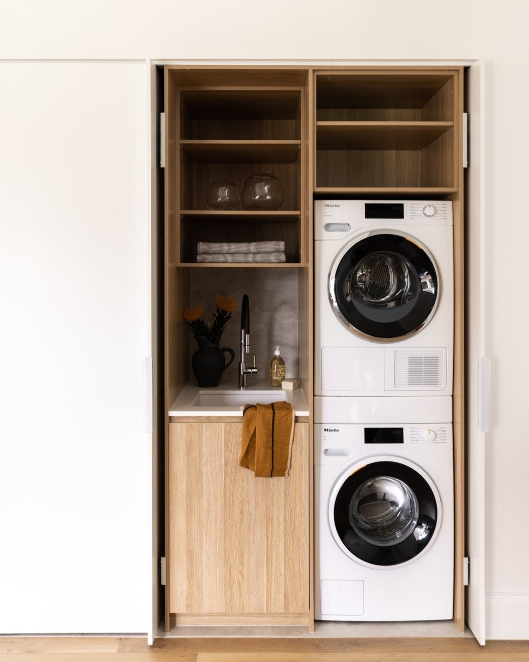 Now you see it .....now you don't. 

Sometimes we don't have the space, nor the need for a large family style laundry. But compact doesn't have to be dull - in fact compact spaces provide a great opportunity to use beautiful finishes.

This European 