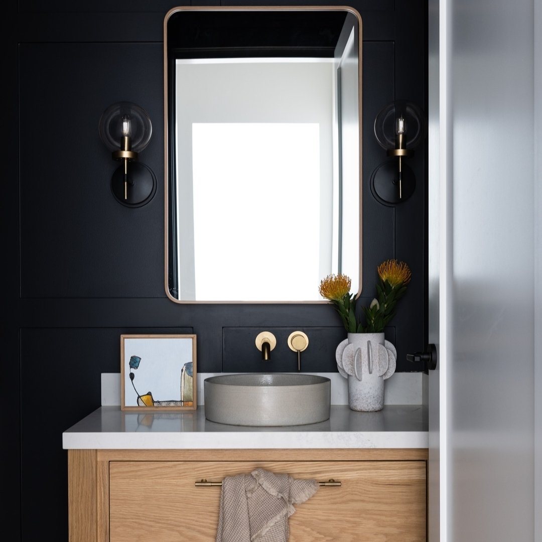 Powder rooms are one of our favourite rooms to design. These small spaces are the perfect canvas for creating big impact - often with colour or pattern that would be too much in a larger space. 

In our Modern Farmhouse project we embraced darker moo