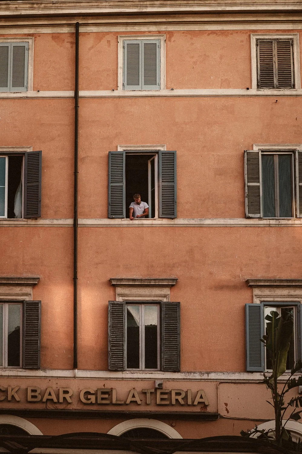 Man Looking out Window above Gelateria.jpg