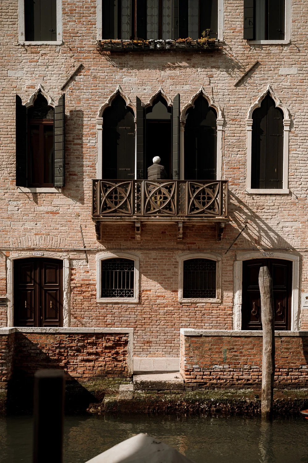 Person on Balcony Over Canal.jpg
