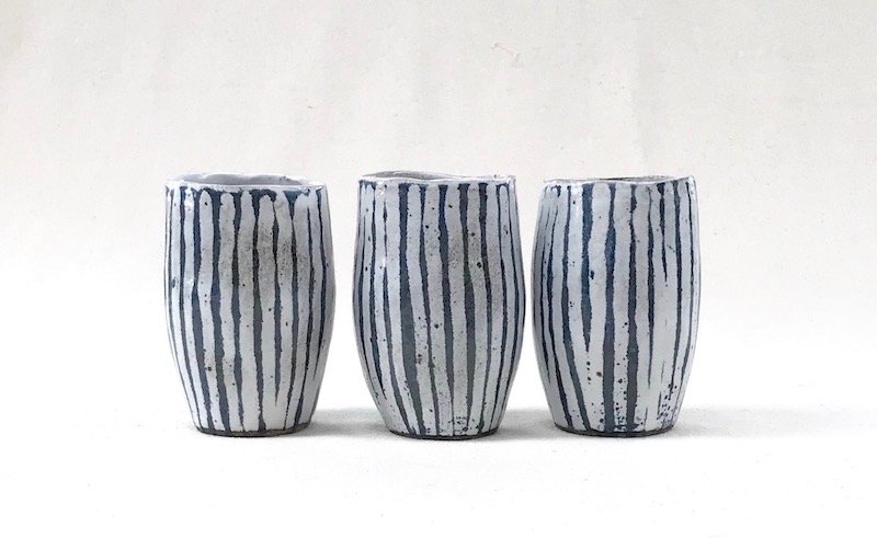 Three hand carved blue and white striped beakers