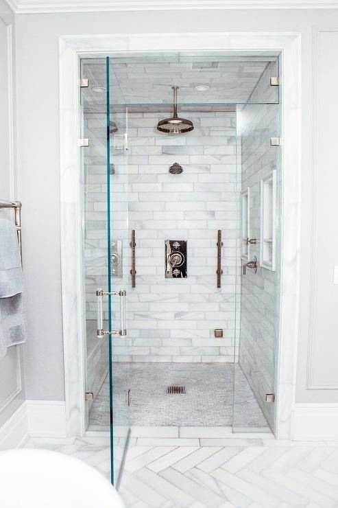 Walk-in shower enclosed with three walls and one door. Image via Pinterest