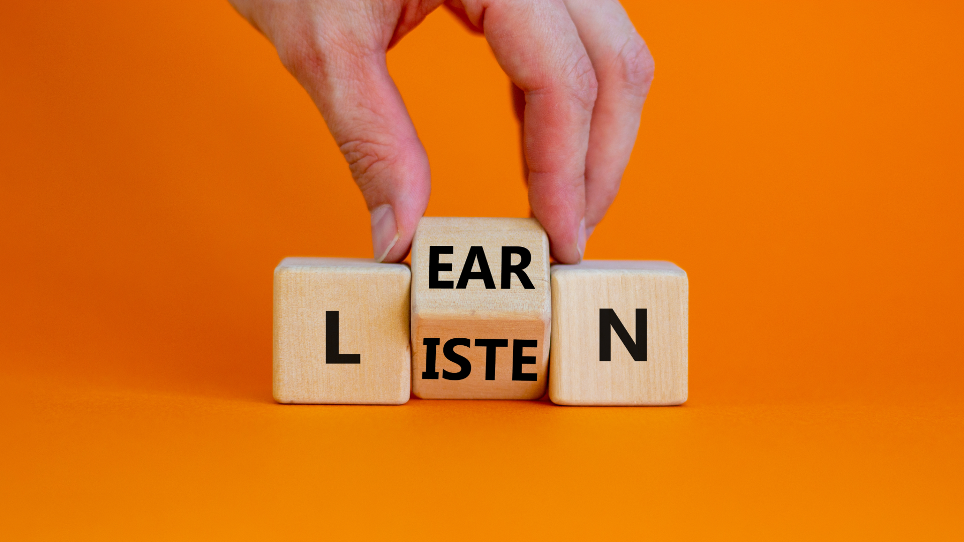 Photograph of wood blocks with two variations: listen and learn
