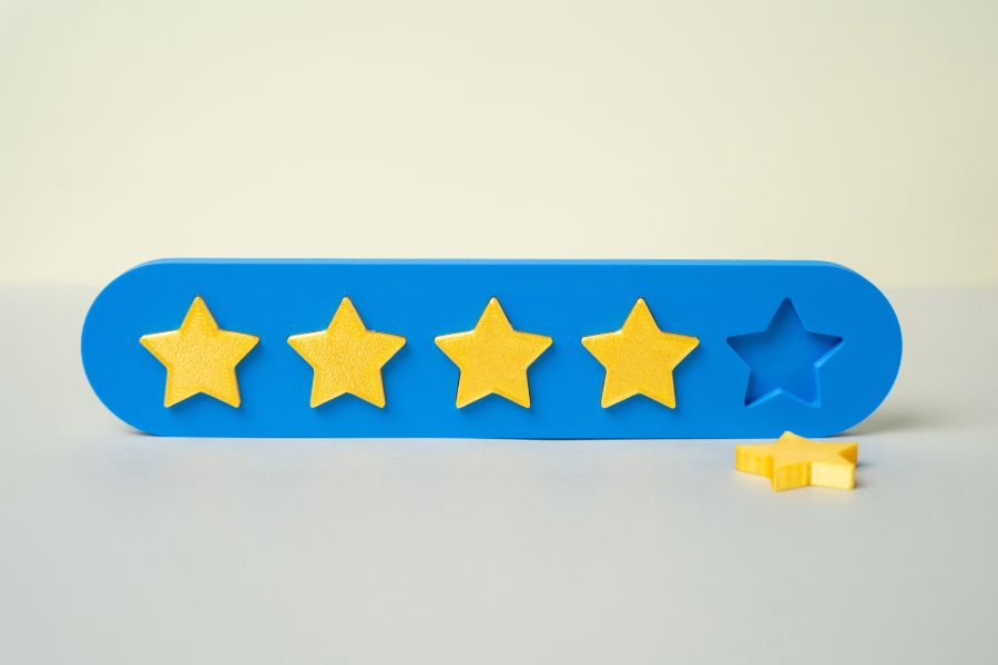 adobe stock image of a wooden block with five yellow stars and the fifth has fallen out