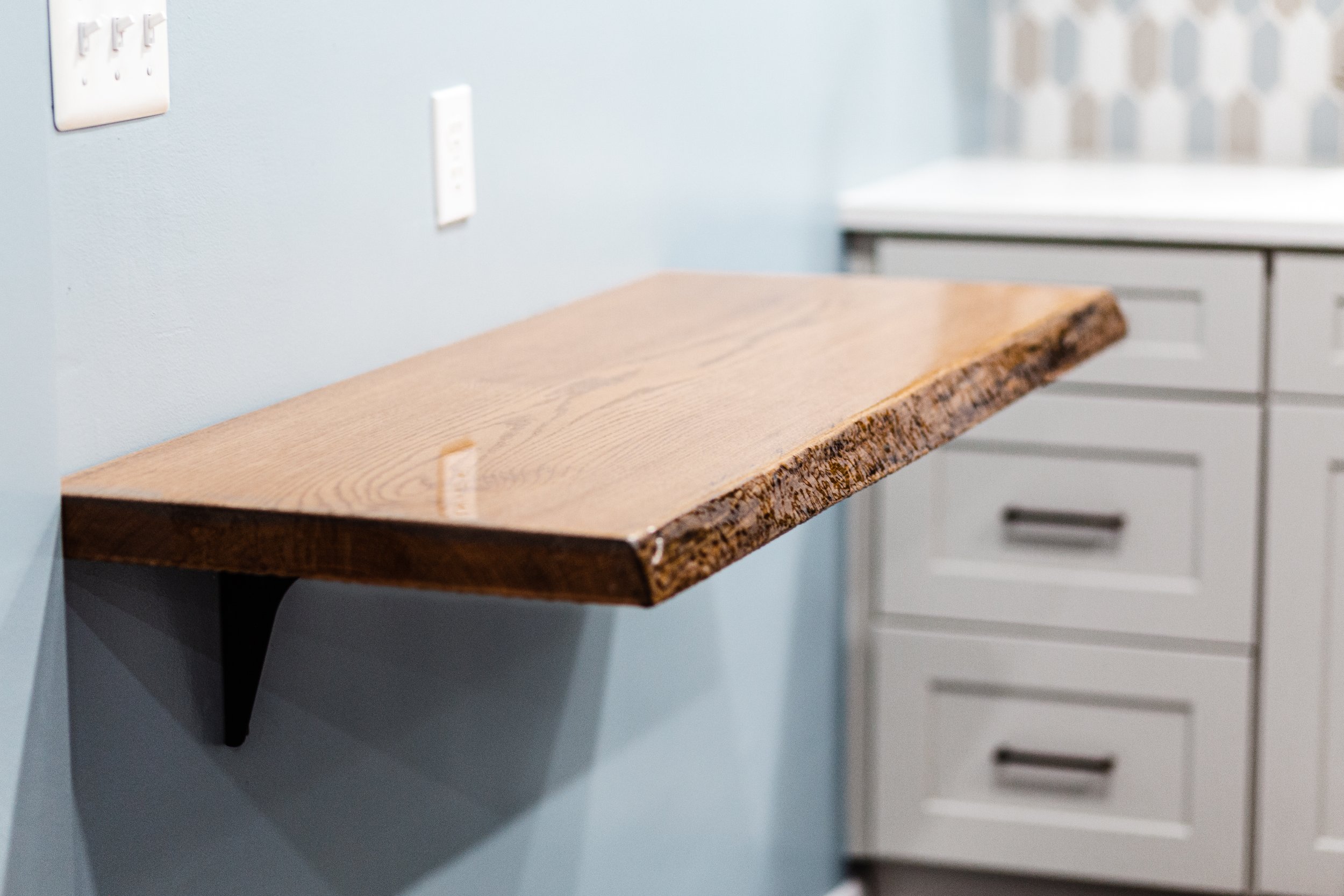 Remodeling the kitchen and dining room of a 1950s Cape Cod in Pittsburgh, PA. Design elements feature gray cabinets, oil-rubbed bronze hardware, neutral-tone picket tile, a live-edge oak slab floating table, and gray floors