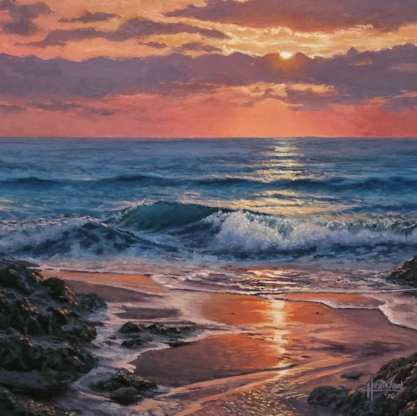 Sunset over the ocean with waves crashing on rocky beach, pink and purple clouds in sky.
