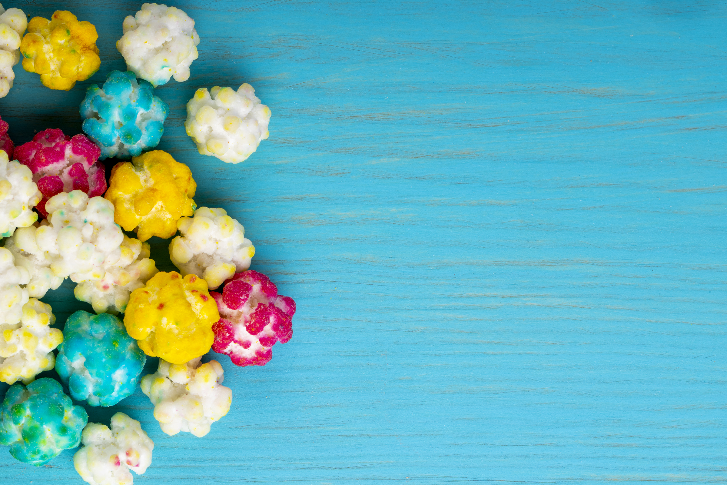 top-view-colorful-sugar-candies-blue-wooden-background-with-copy-space_2400.png