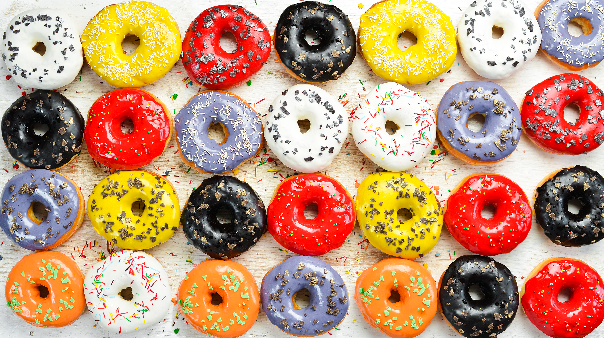 set-sweet-colored-donuts-white-wooden-background-top-view-flat-lay_2400.png