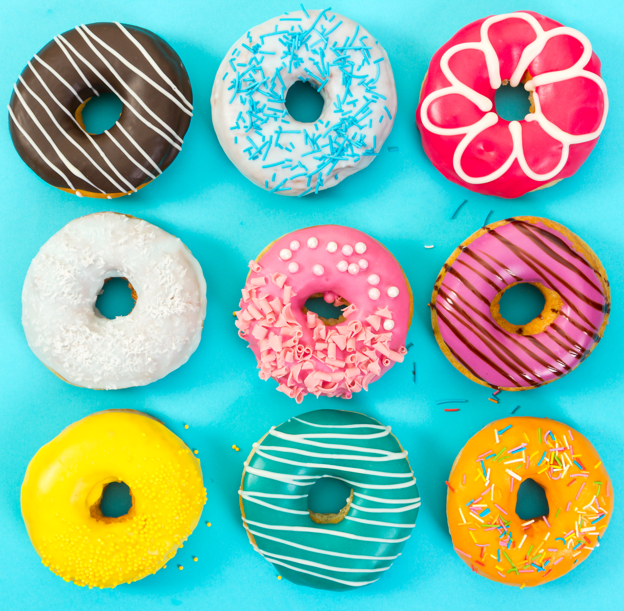 various-colorful-donuts-blue-background-top-view_2400.png