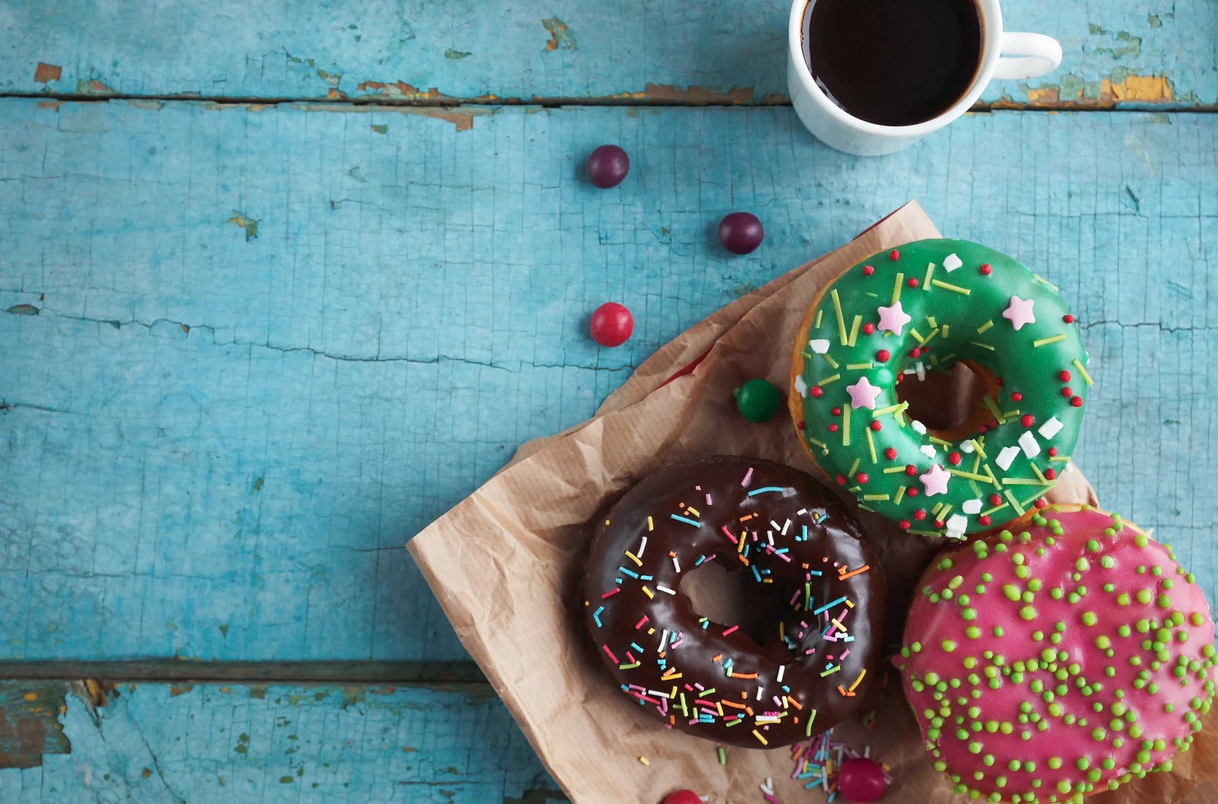 homemade-colorful-donuts-black-coffee-rustic-turquoise-wooden-table.jpg