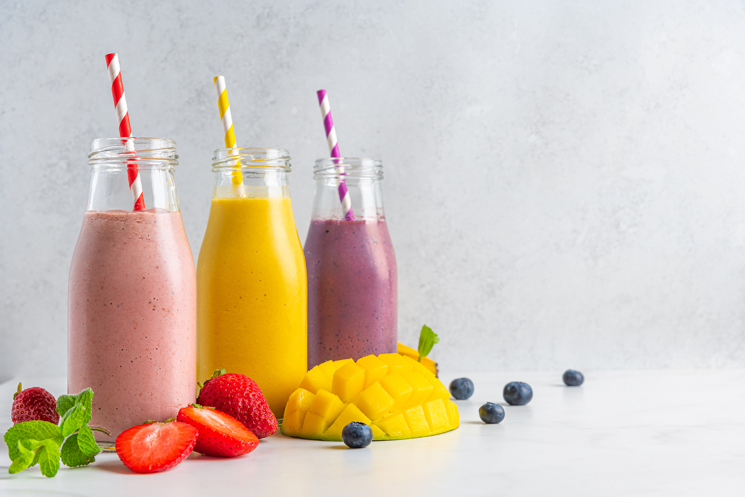 fruit-berry-smoothie-bottles-with-straw-fresh-fruits-summer-tropical-refreshing-drinks_2400.png