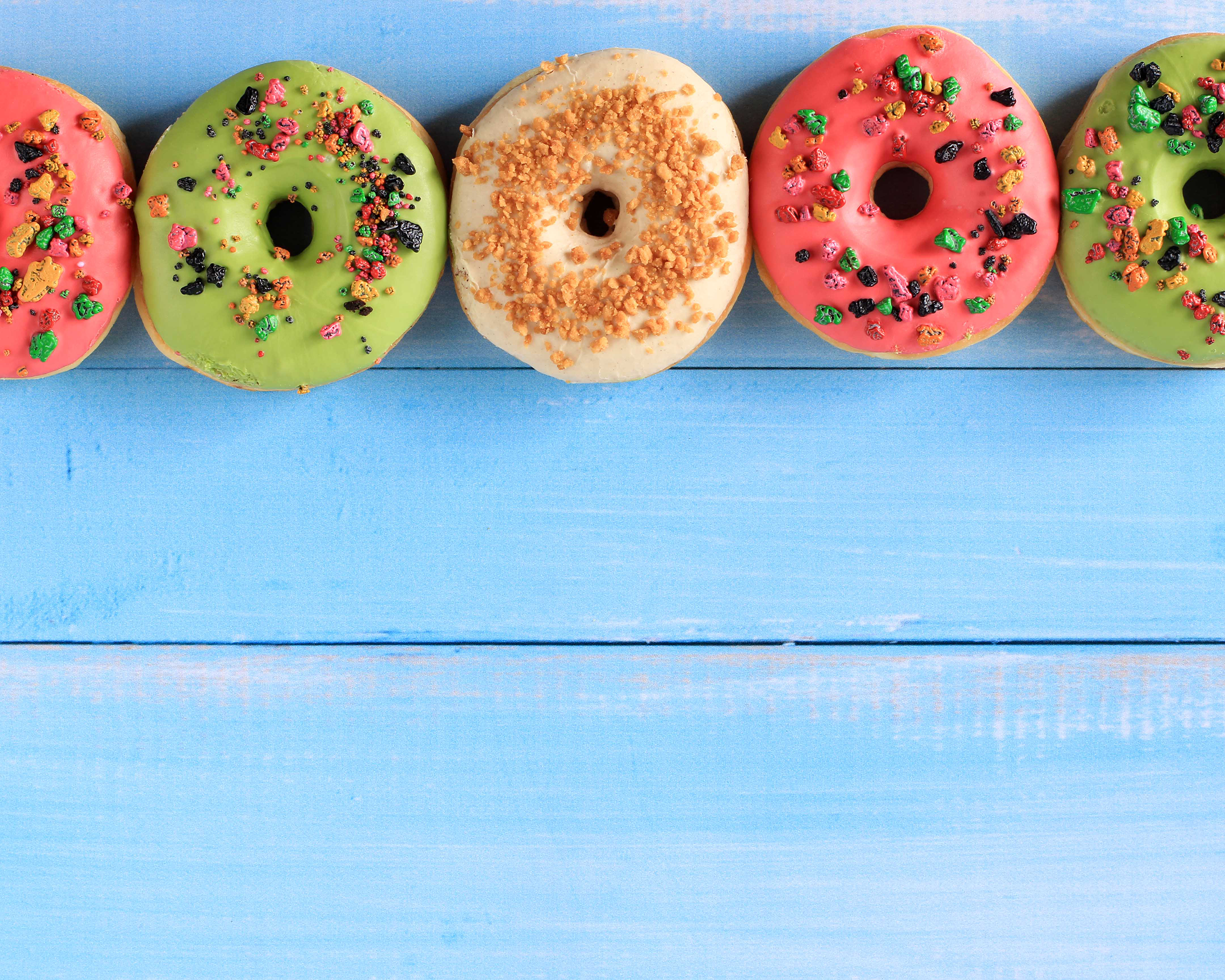 top-view-assorted-doughnut-with-colorful-sprinkle-isolated-blue-wooden-background-copy-space_2400.png
