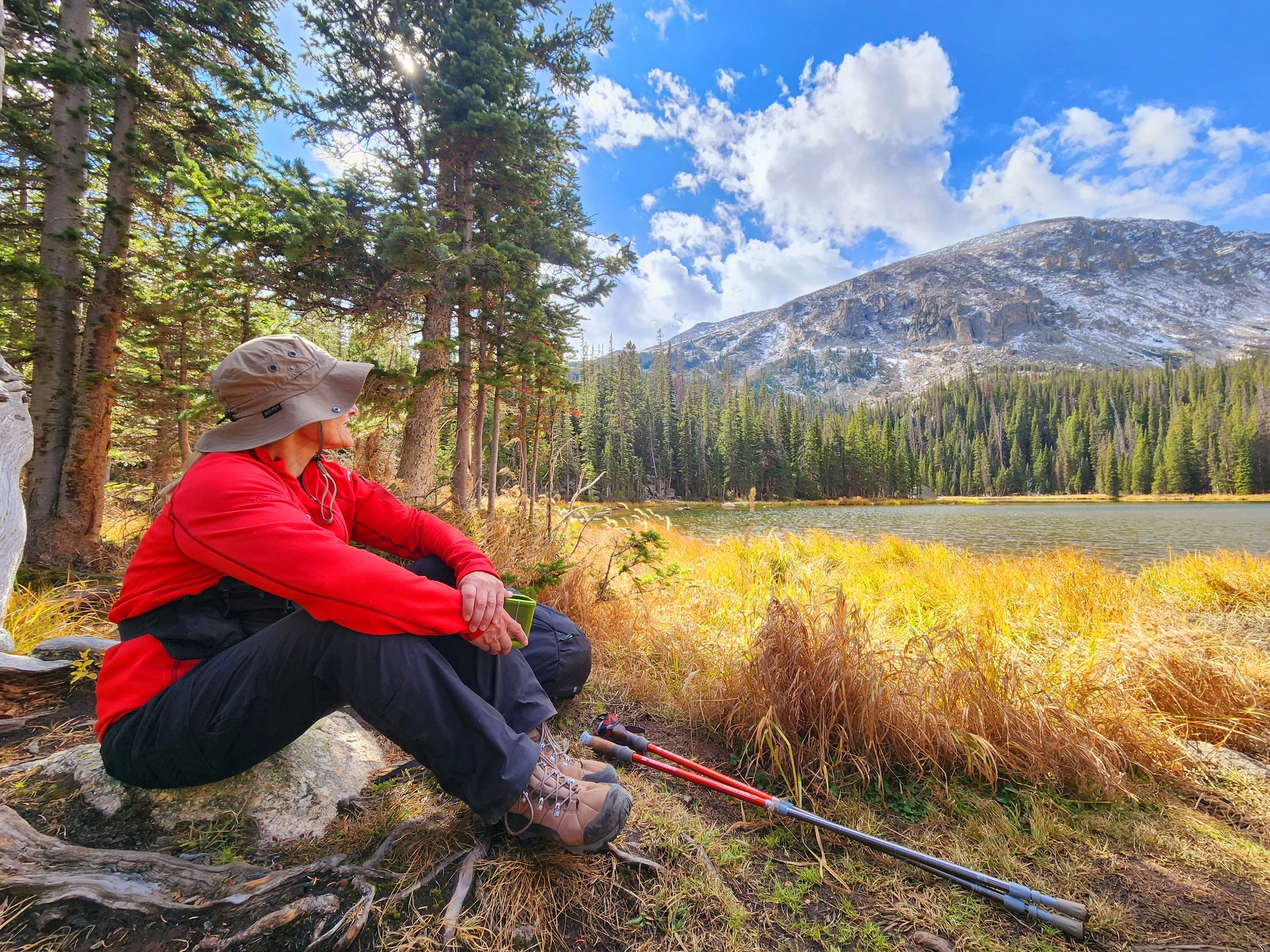 Femme Trek guest looking across Ouzel Lake on a private women-only guided hiking tour with femme trek in rocky mountain national park