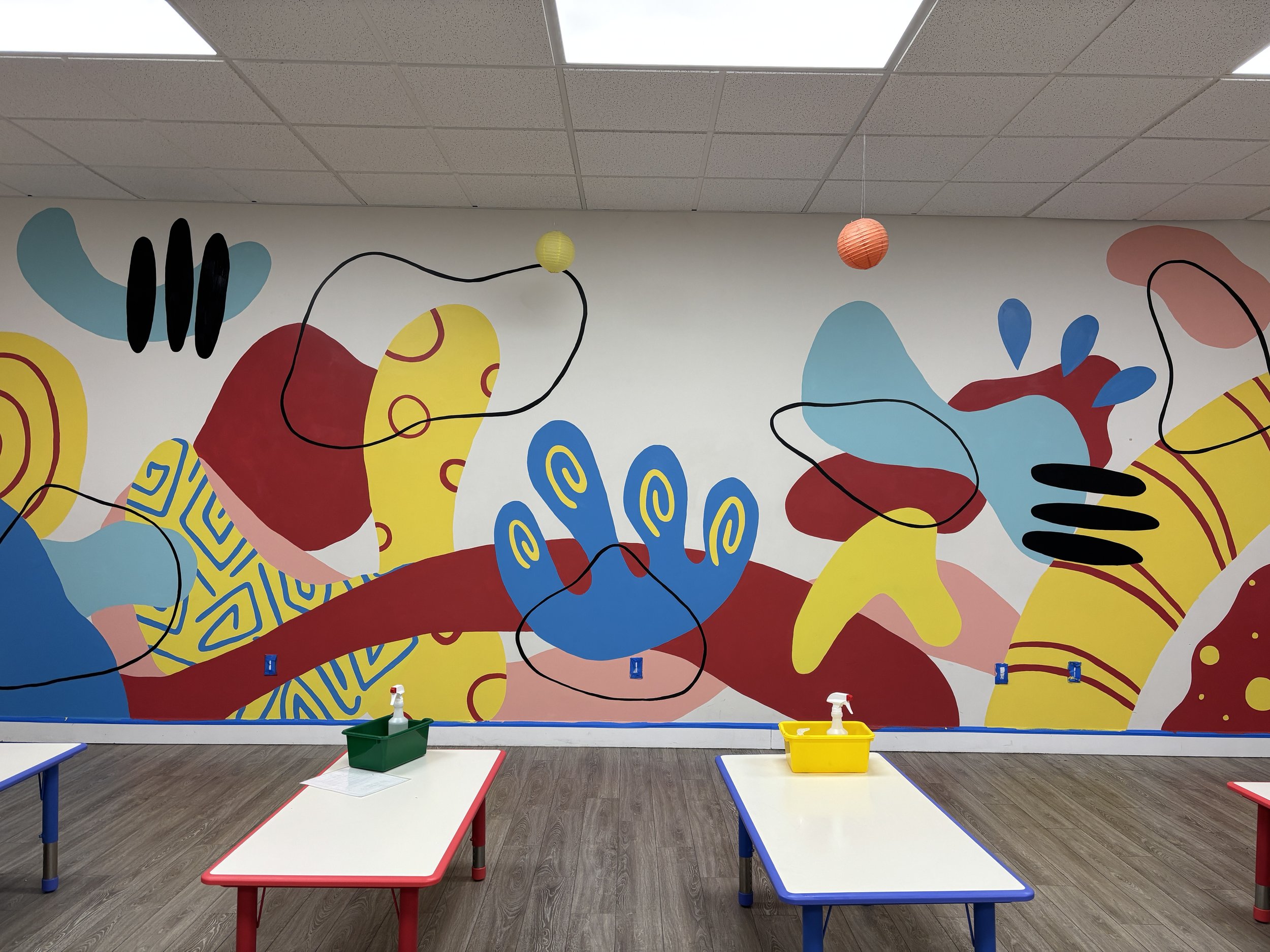 Organic shaped mural wall using a primary color scheme.  