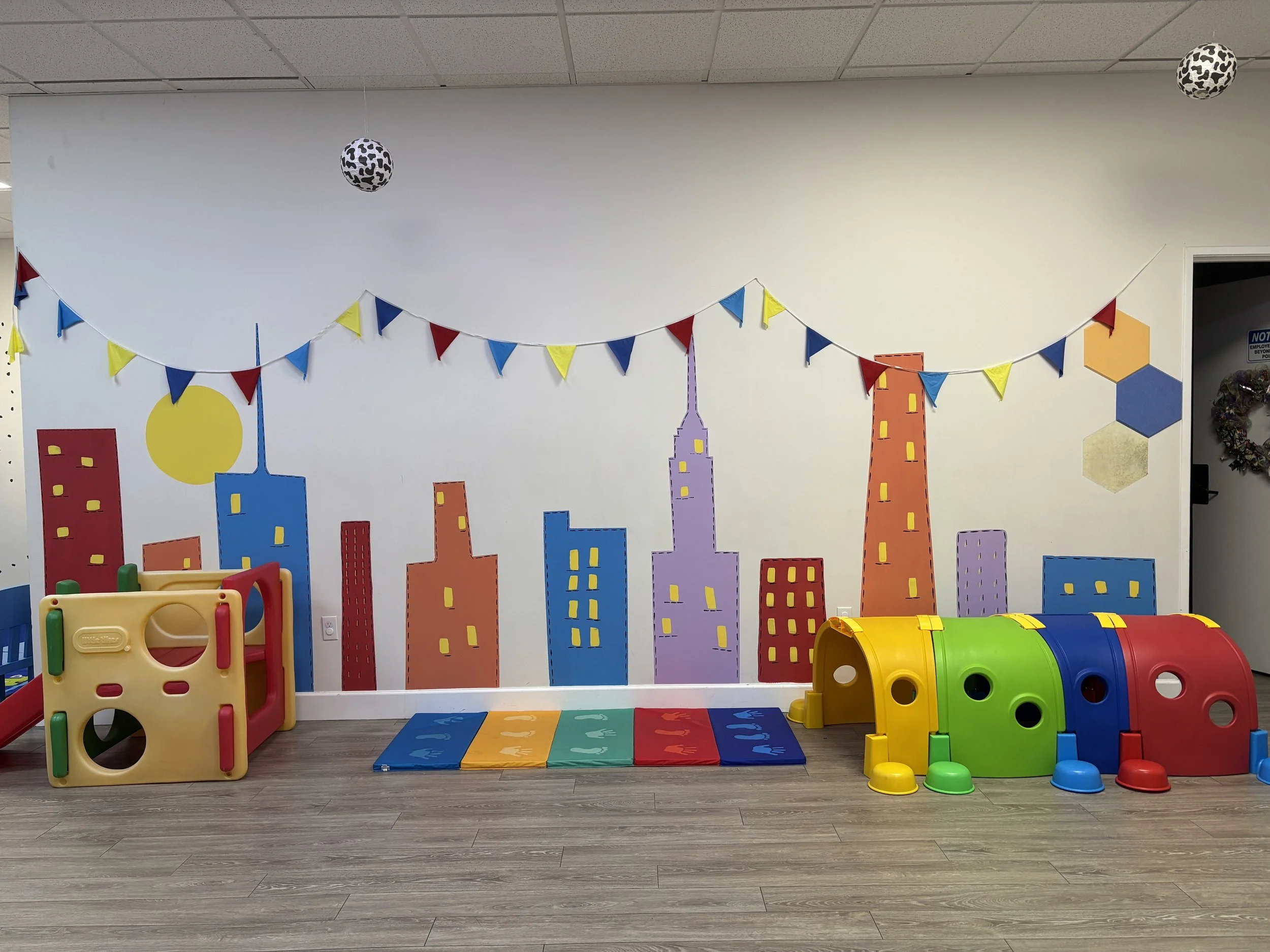 Wall mural with cityscape and kids toys.  