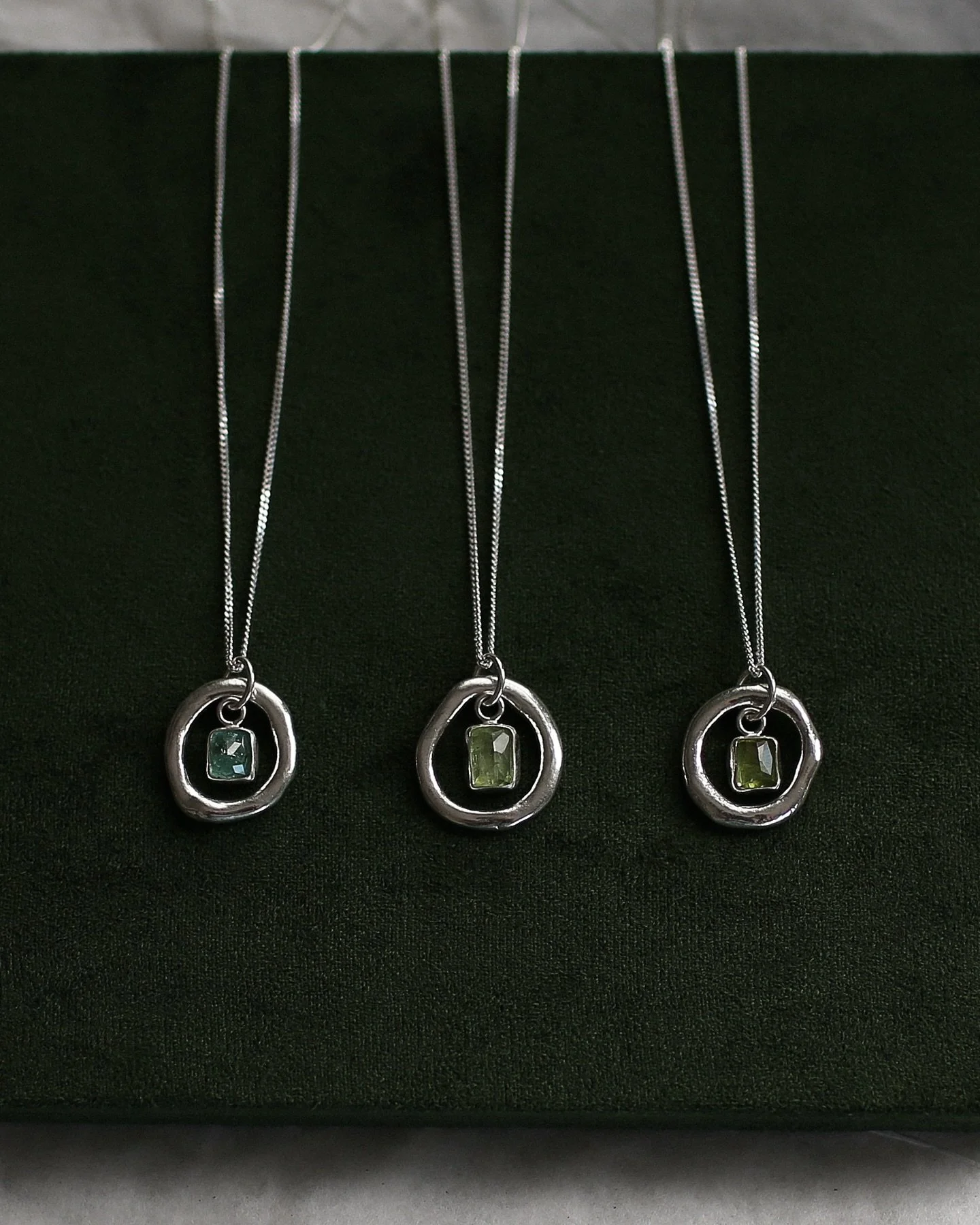 Sol Catcher pendants, each with a molten ring wrapped around sweet tourmaline stones ~ like holding a little spark of your soul, flowing and moving with you. 💫

.
.
.

#solmayjewelry #uniquependant #newcollection #necklaceoftheday #silversmithjewelr