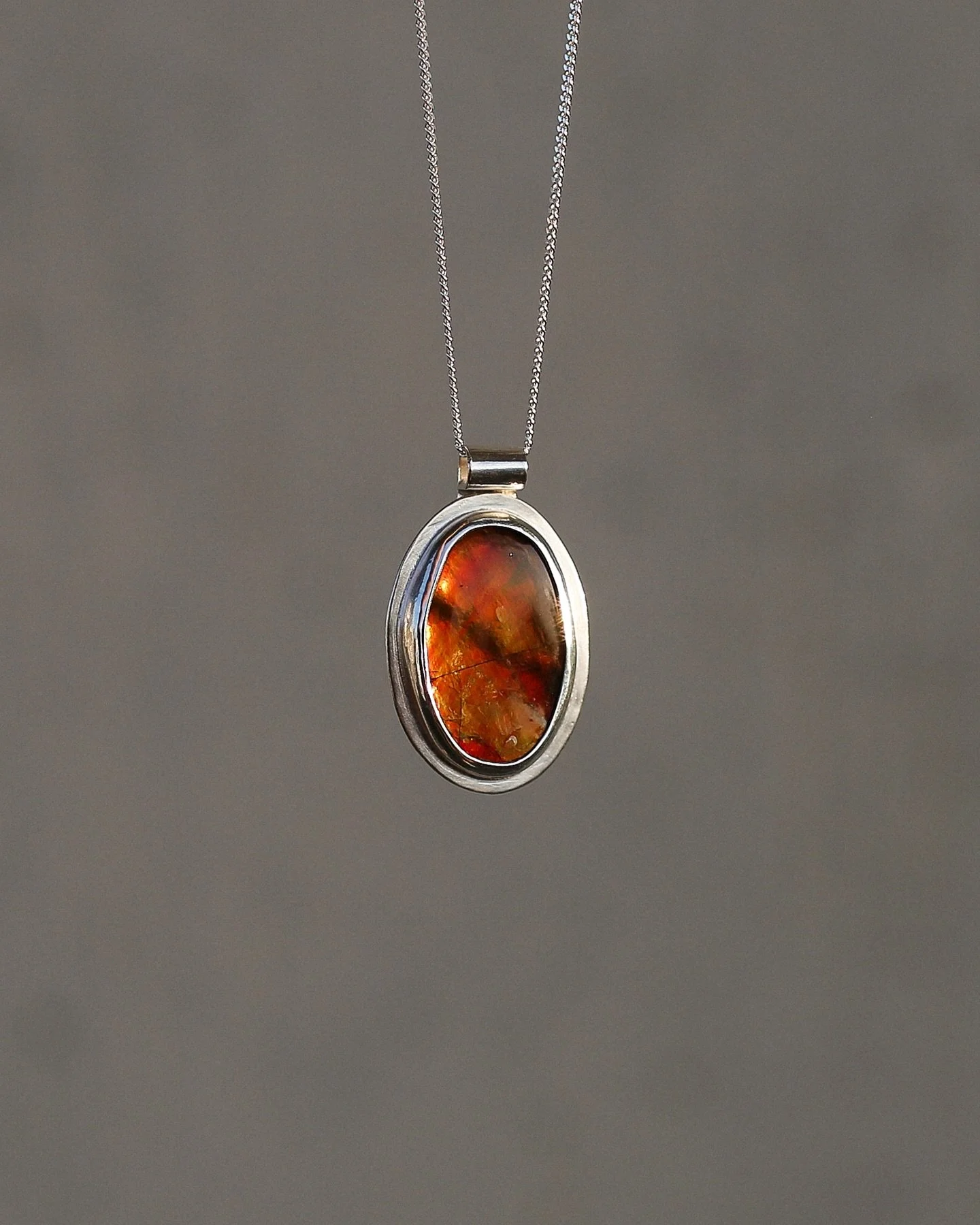 *Sold* Ember Pendant: Glowing orange and red, and even a touch of green when the light hits just right. The stone is Ammolite (a rare fossilized shell). This one is truly one of a kind, feels like carrying a spark from a golden autumn day.✨

.
.
.

#