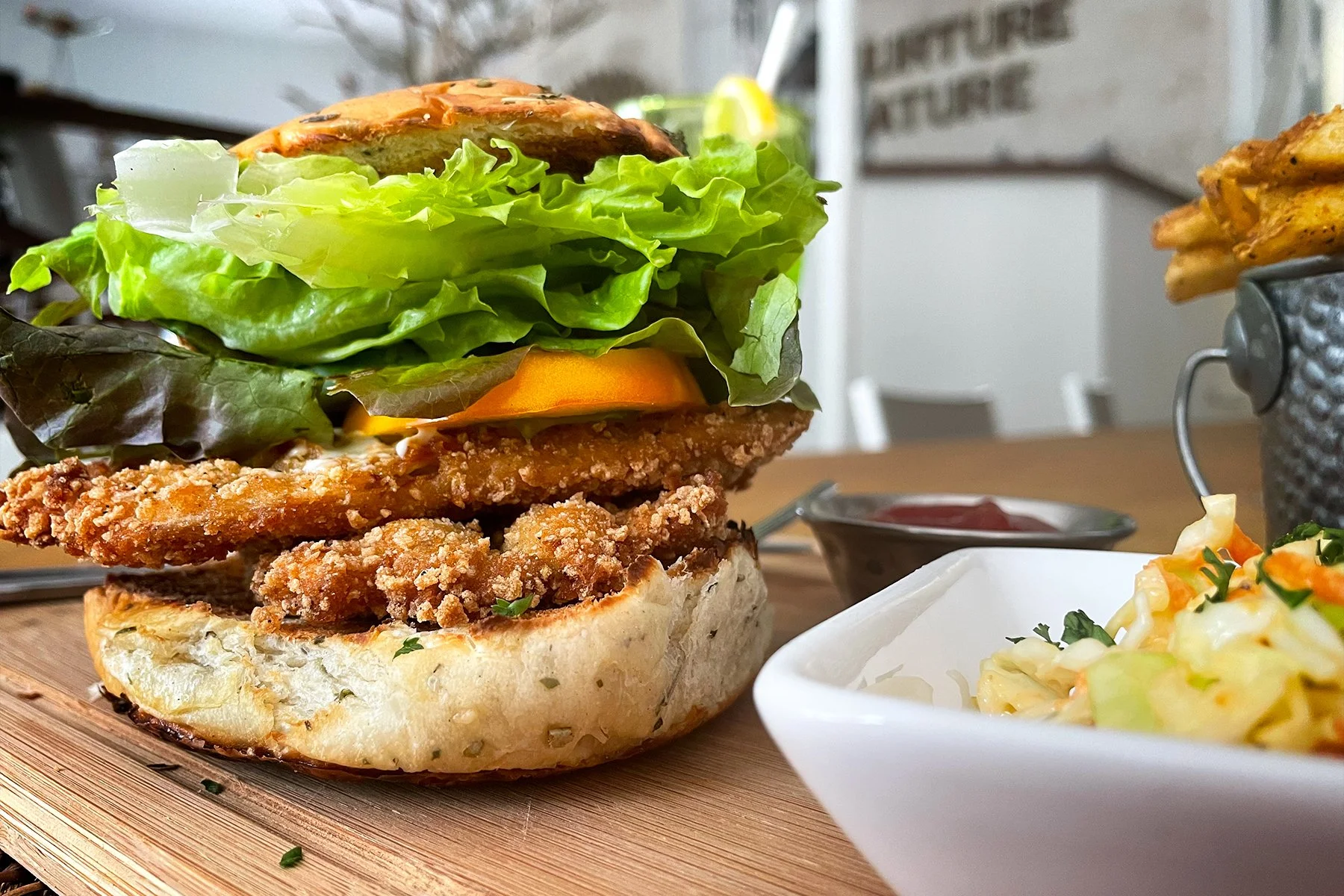 CRISPY FLYING FISH SANDWICH    
served with cucumber, aioli sauce, lettuce, tomatoes, with sides of spicy french fries and coleslaw
