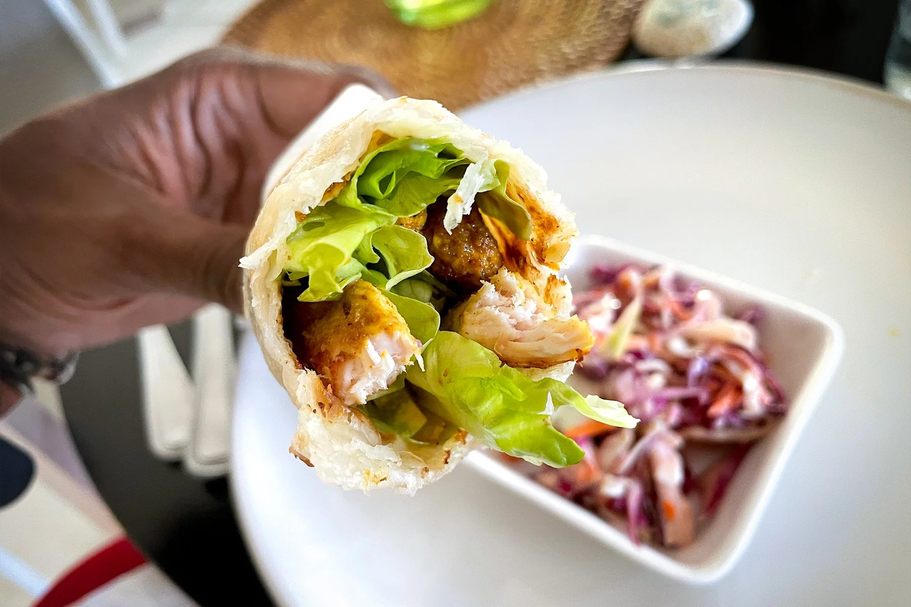 LIGHT AND FLAKY CHICKEN WRAP    
filled with chicken, lettuce, tomatoes, cucumber, and spicy curry sauce, with coleslaw side
