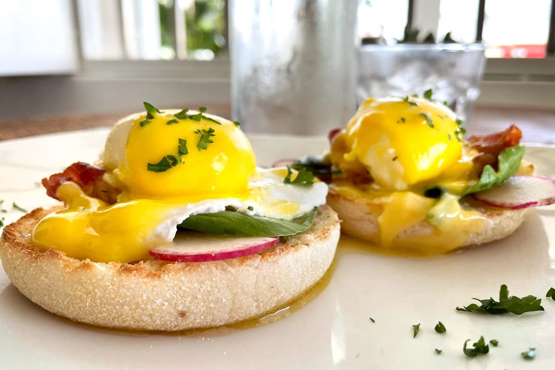 EGGS BENEDICT    
served on an english muffin with bacon, spinach, and hollandaise sauce