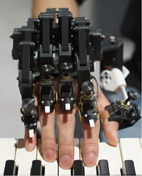 Surpassing Limits of Virtuosity of Pianists by Exoskeleton, 2025, Shinichi Furuya(JP). Photo credit: Sony CSL / NeuroPiano