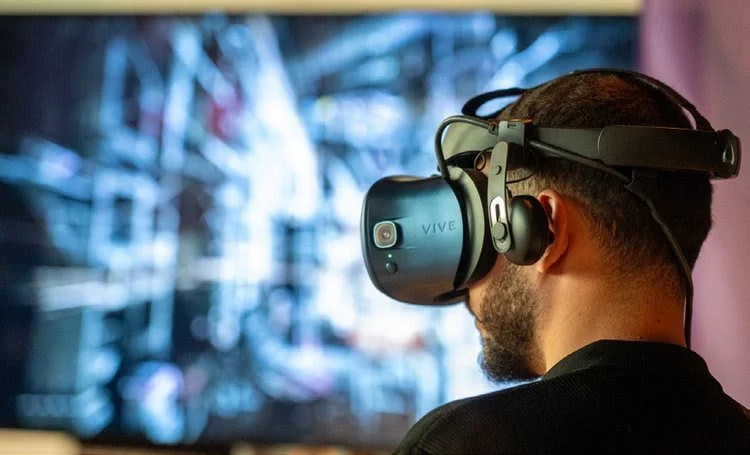 A person wearing an AR headset looking at a screen