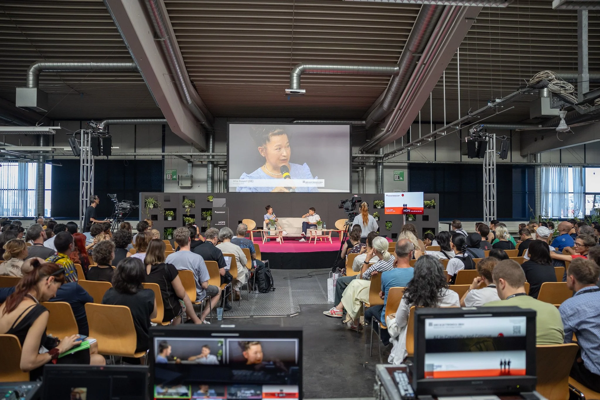 AI in Creativity and Critique — A fireside chat with Hito Steyerl (DE), AC Coppens (FR). ARS ELECTRONICA FESTIVAL 2024, Photo showing: Hito Steyerl (on Screen). Photo credit: flap