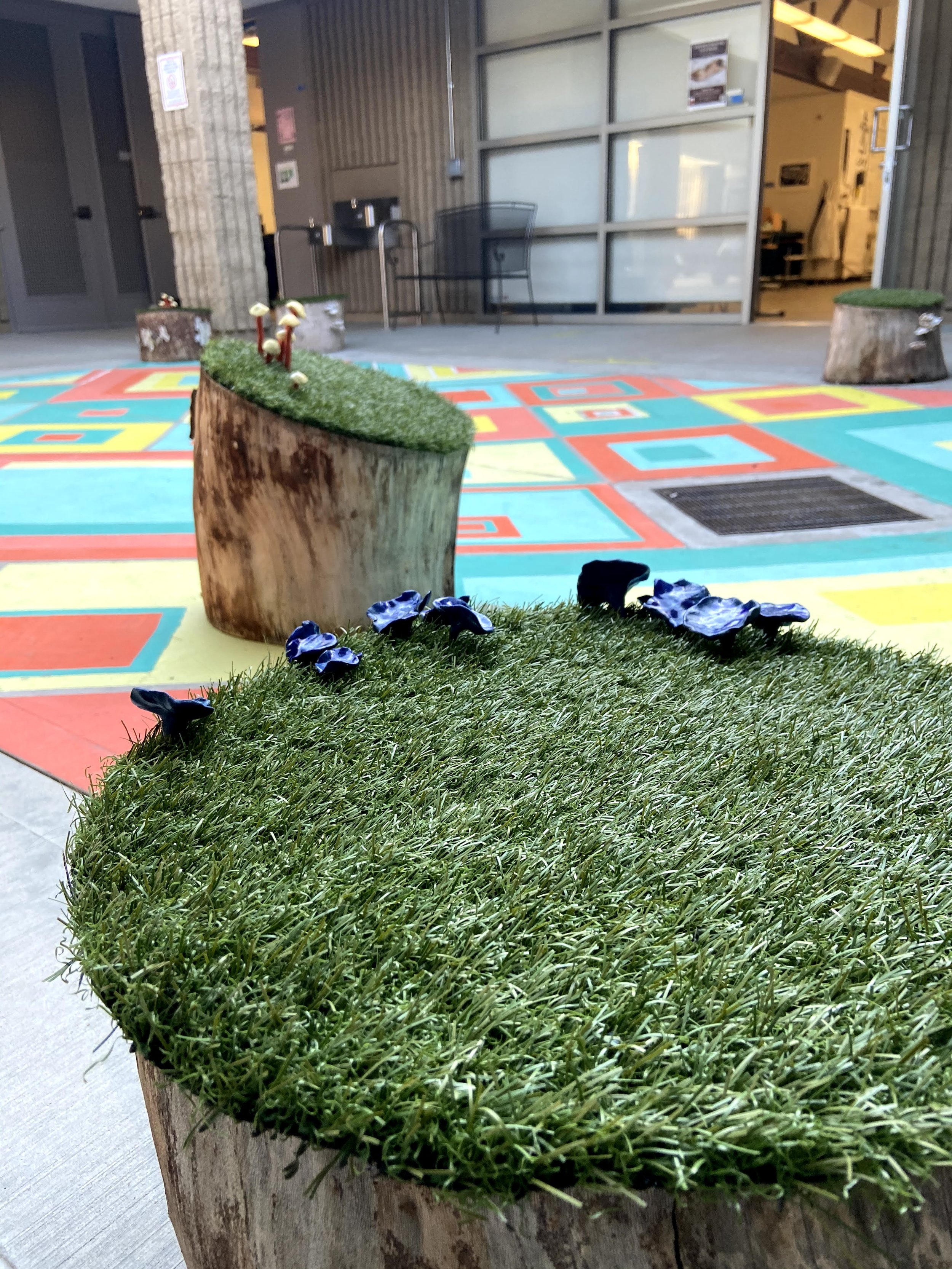 Ceramic students added fungai to the tree stump seating.