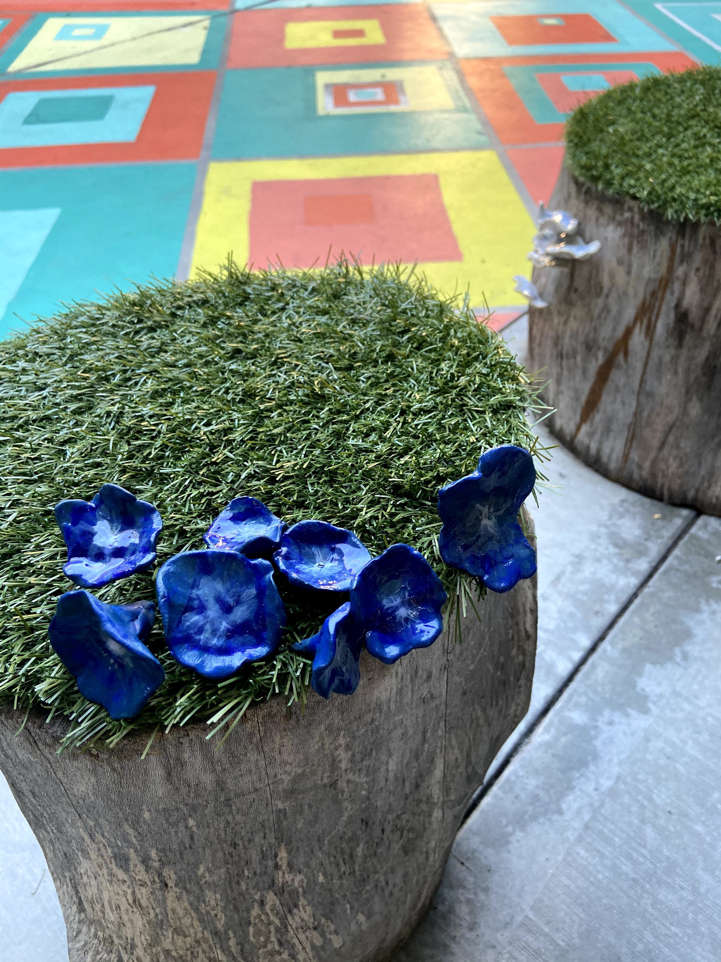 Ceramic students added fungai to the tree stump seating.