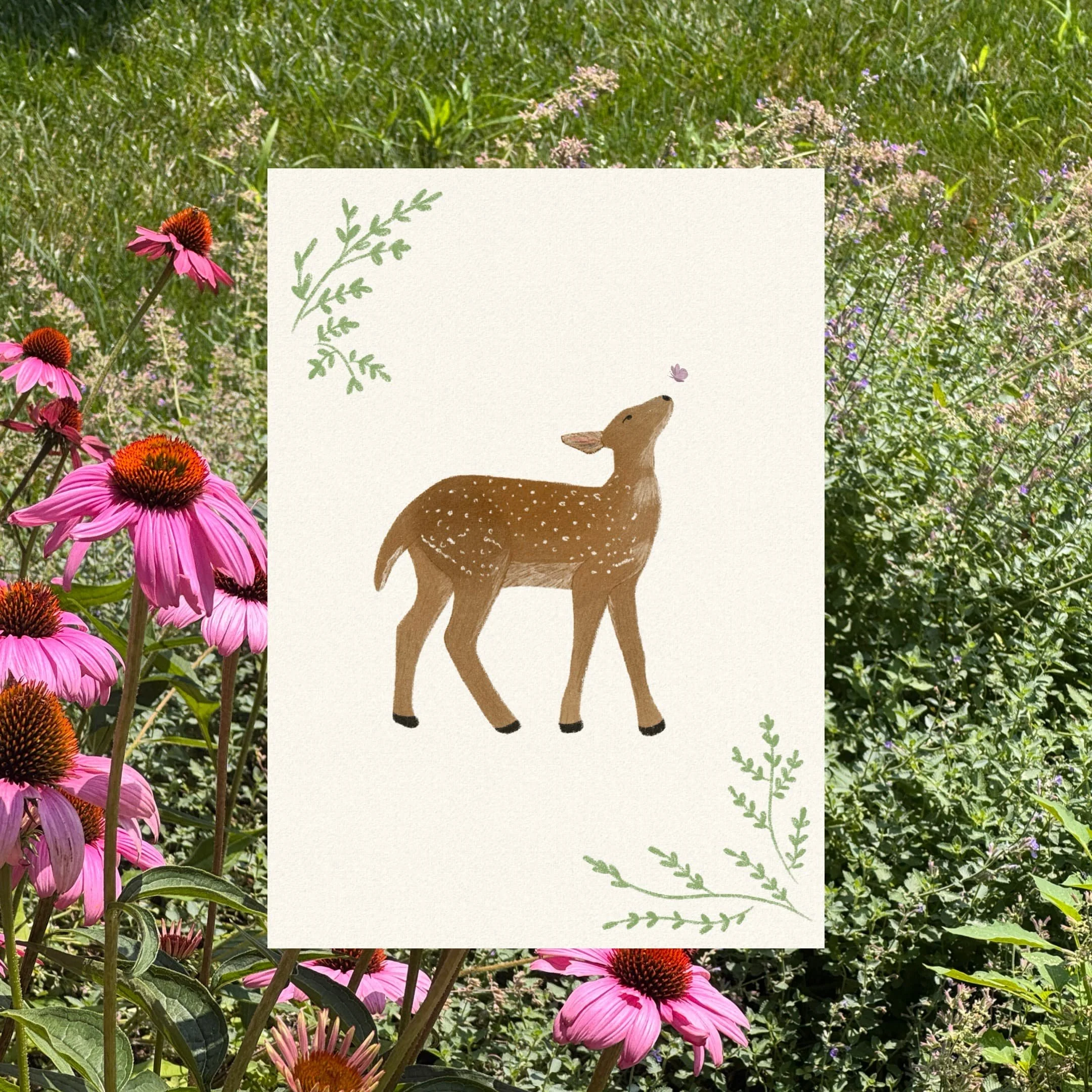 A colorful illustration of a deer standing in a grassy area, with leaves and blossoms in the background.