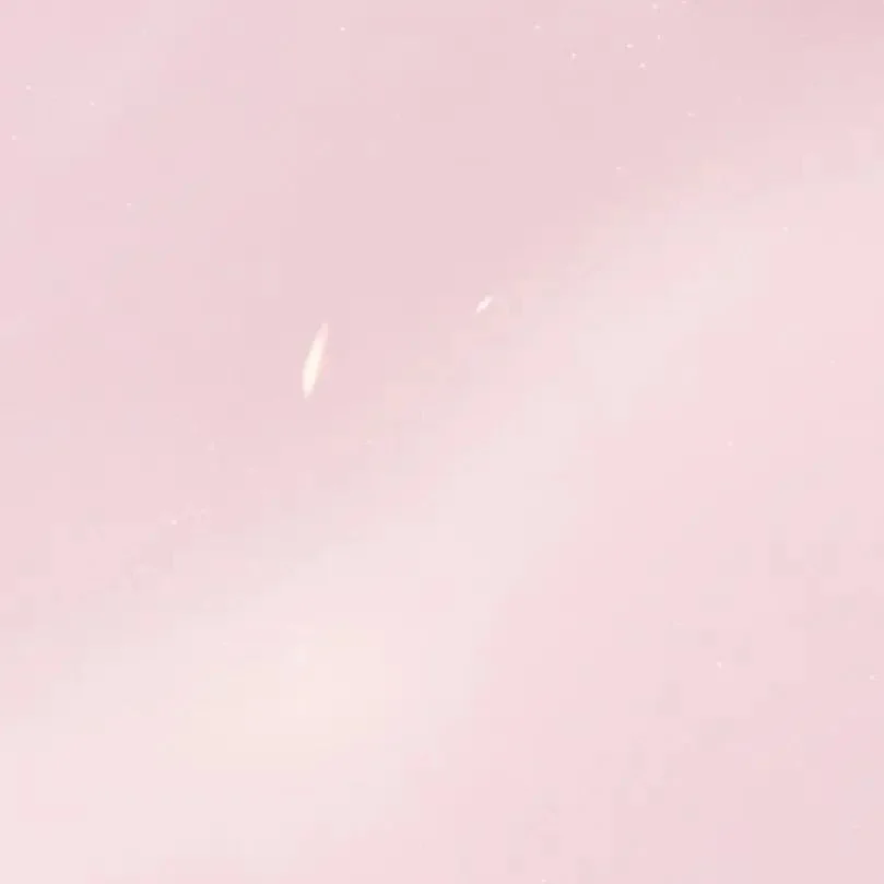 Abstract pink textured background with soft gradient and subtle light spots.