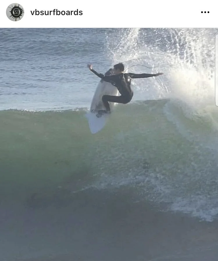 A person surfing on a wave in the ocean.