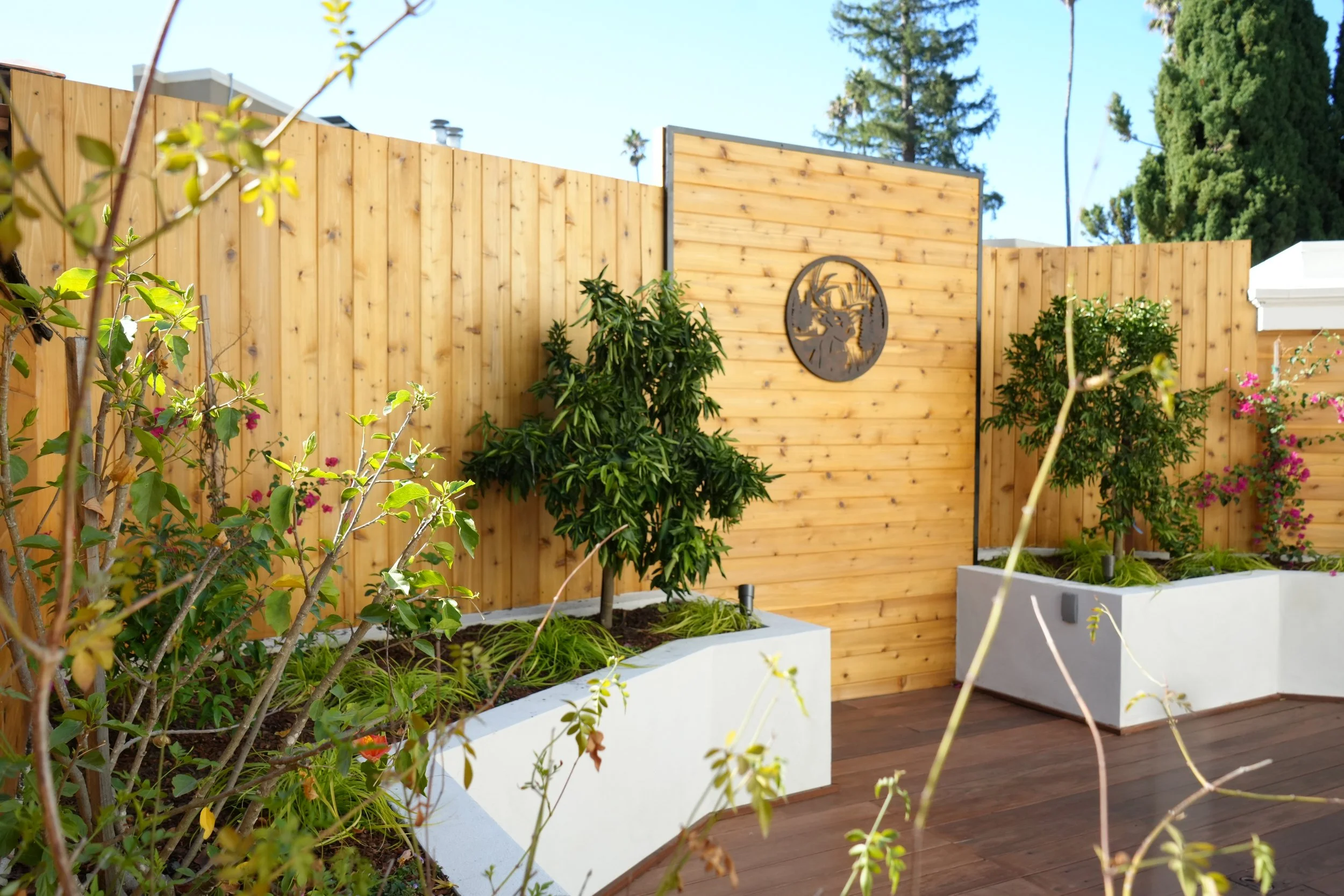 1. Modern Wooden Fence with Raised Planters and Greenery.JPG