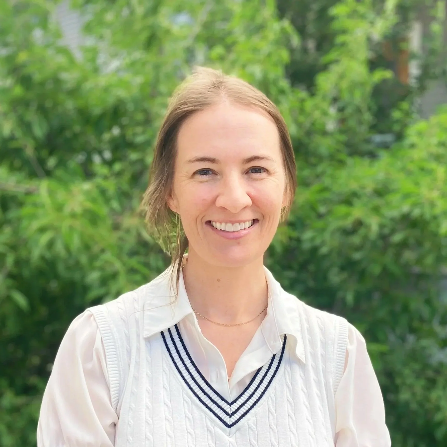 White woman with brown hair smiling