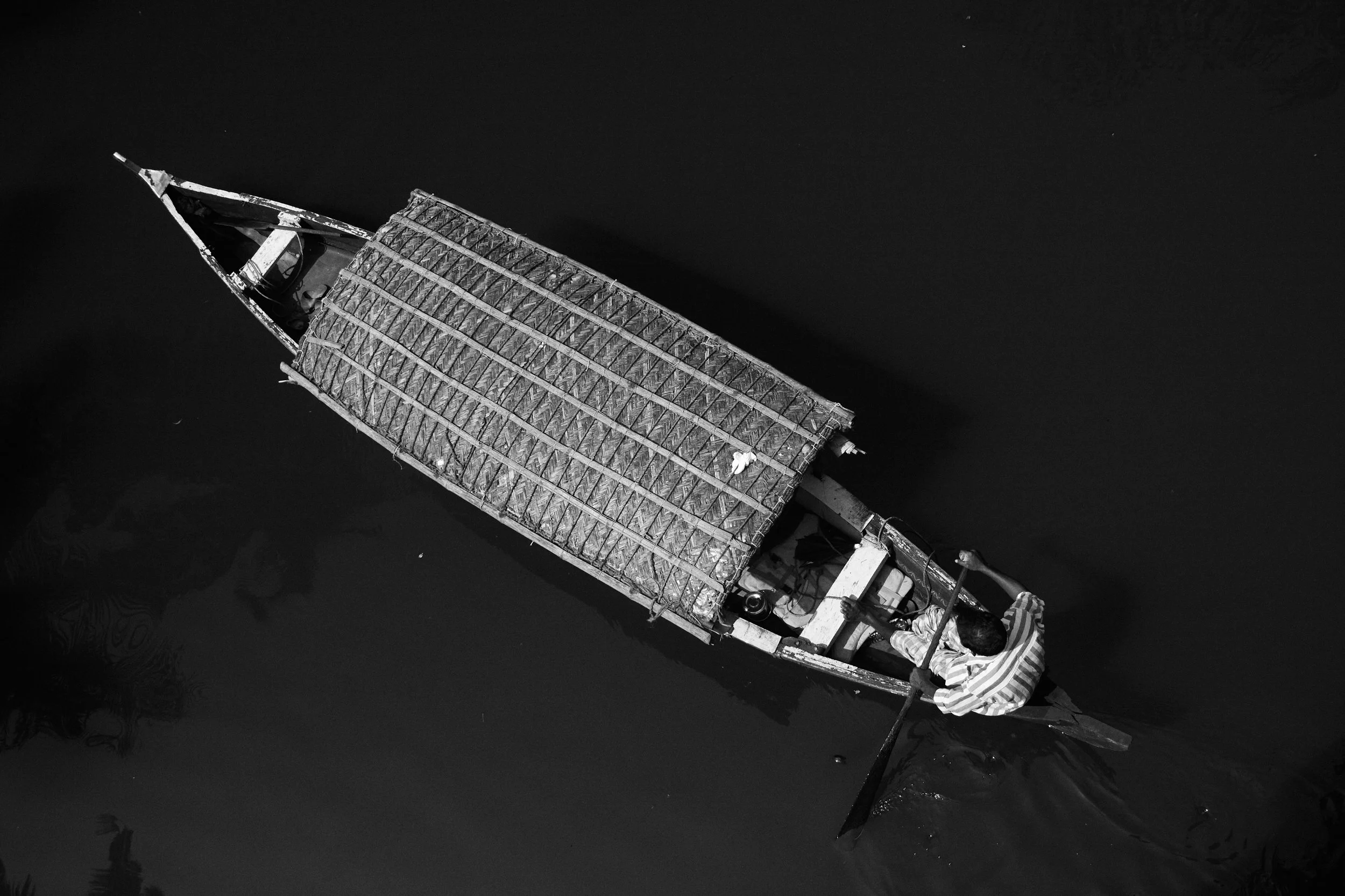 A wooden boat traveling on the backwaters.
