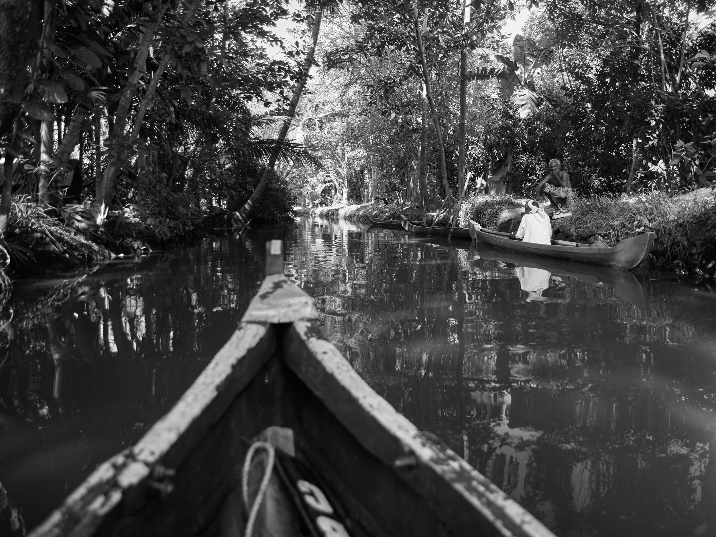 Villagers having a friendly chat at the banks of a small canal.
