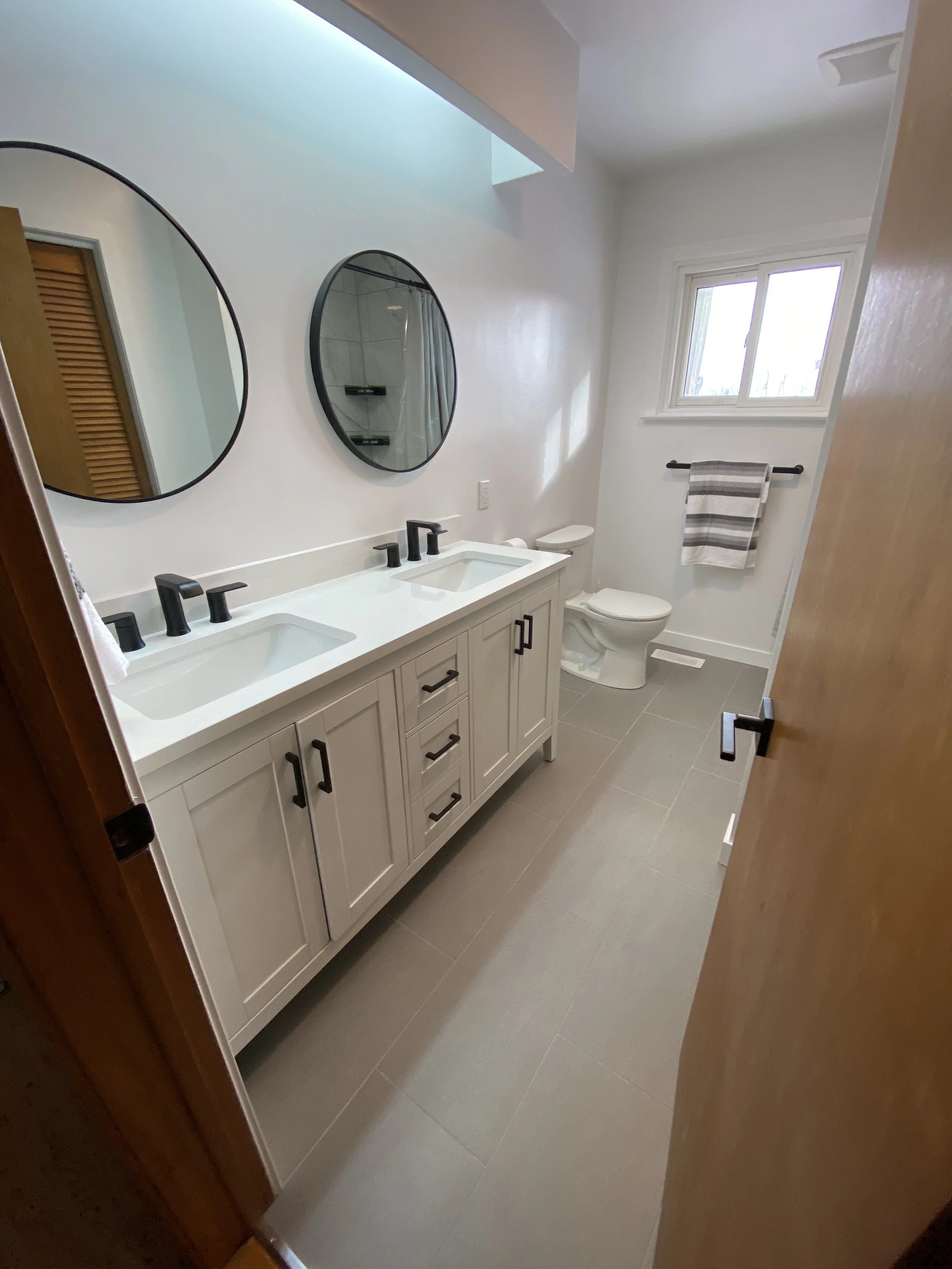 Fully completed bathroom plumbing and fixture replacement in Newmarket, featuring upgraded sink, shower, and toilet installations