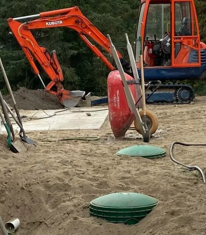 Septic tank access lids exposed during installation and repair work