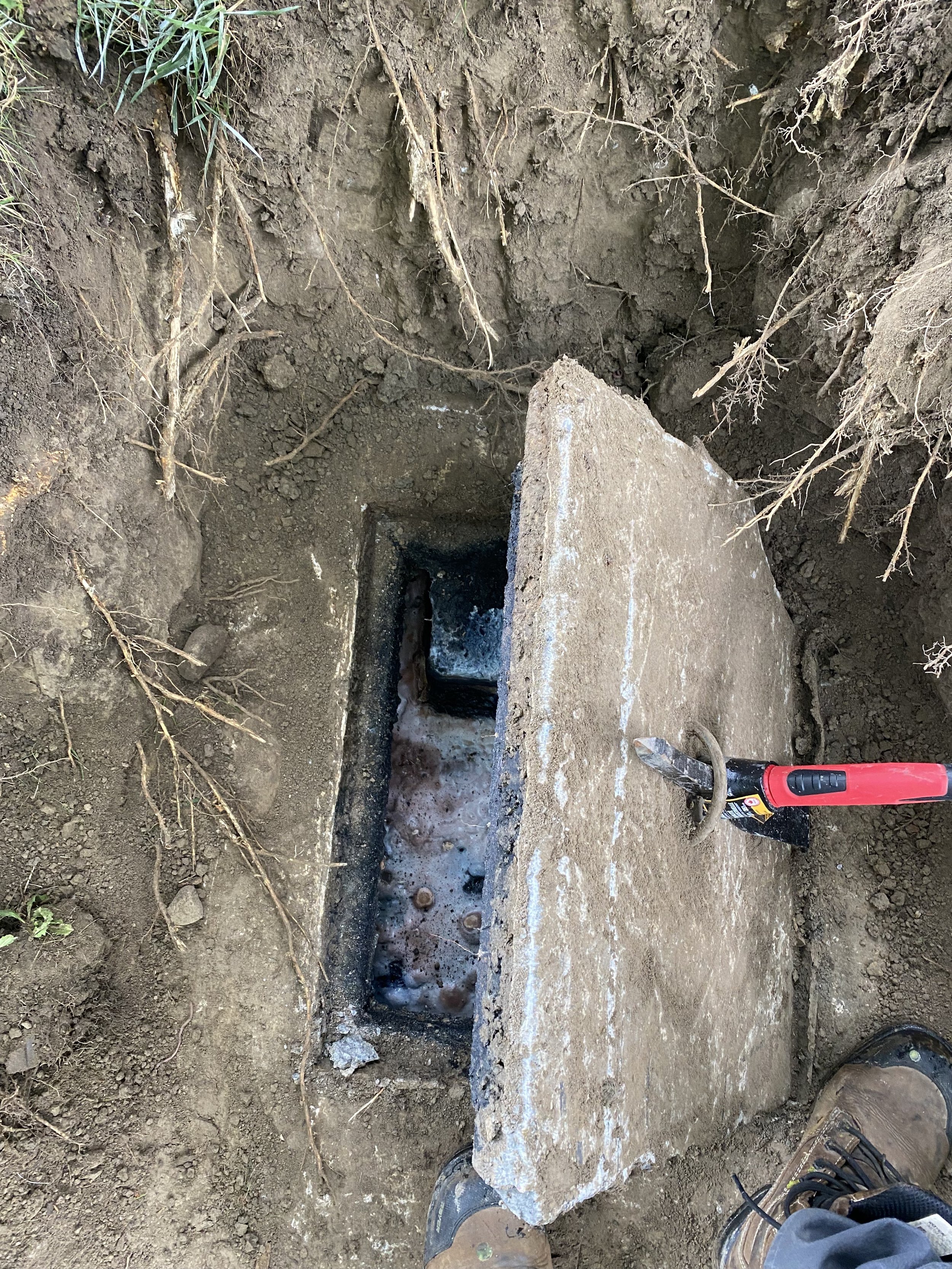Licensed septic system inspector opening septic tank lid for property inspection in York Region Ontario