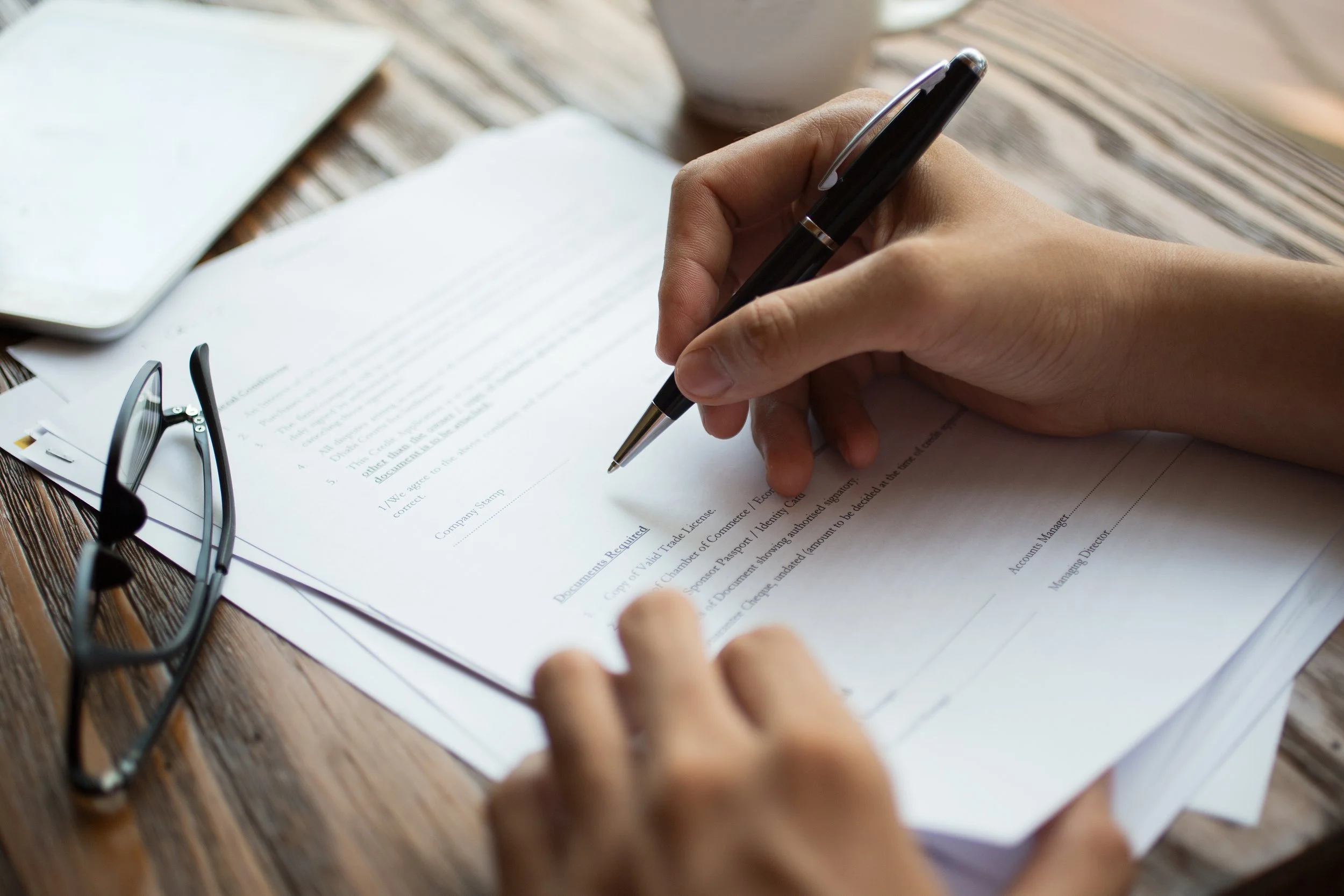 businessman-examining-papers-table.jpg