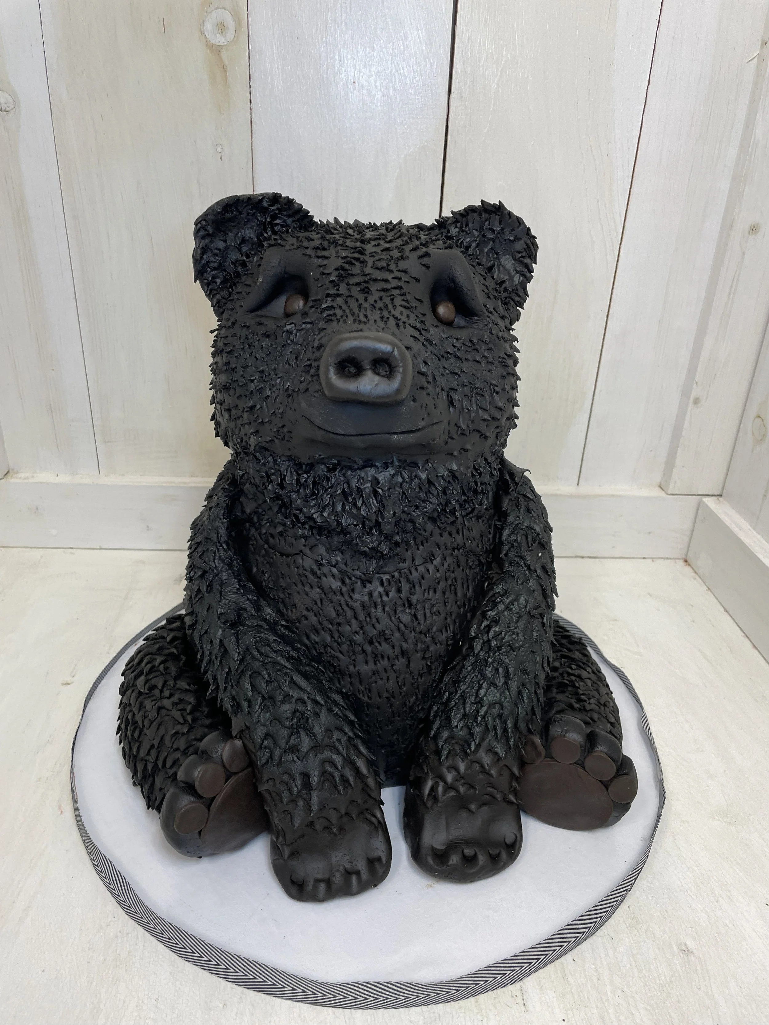 sculpted 3D black bear cake with kind eyes.jpeg
