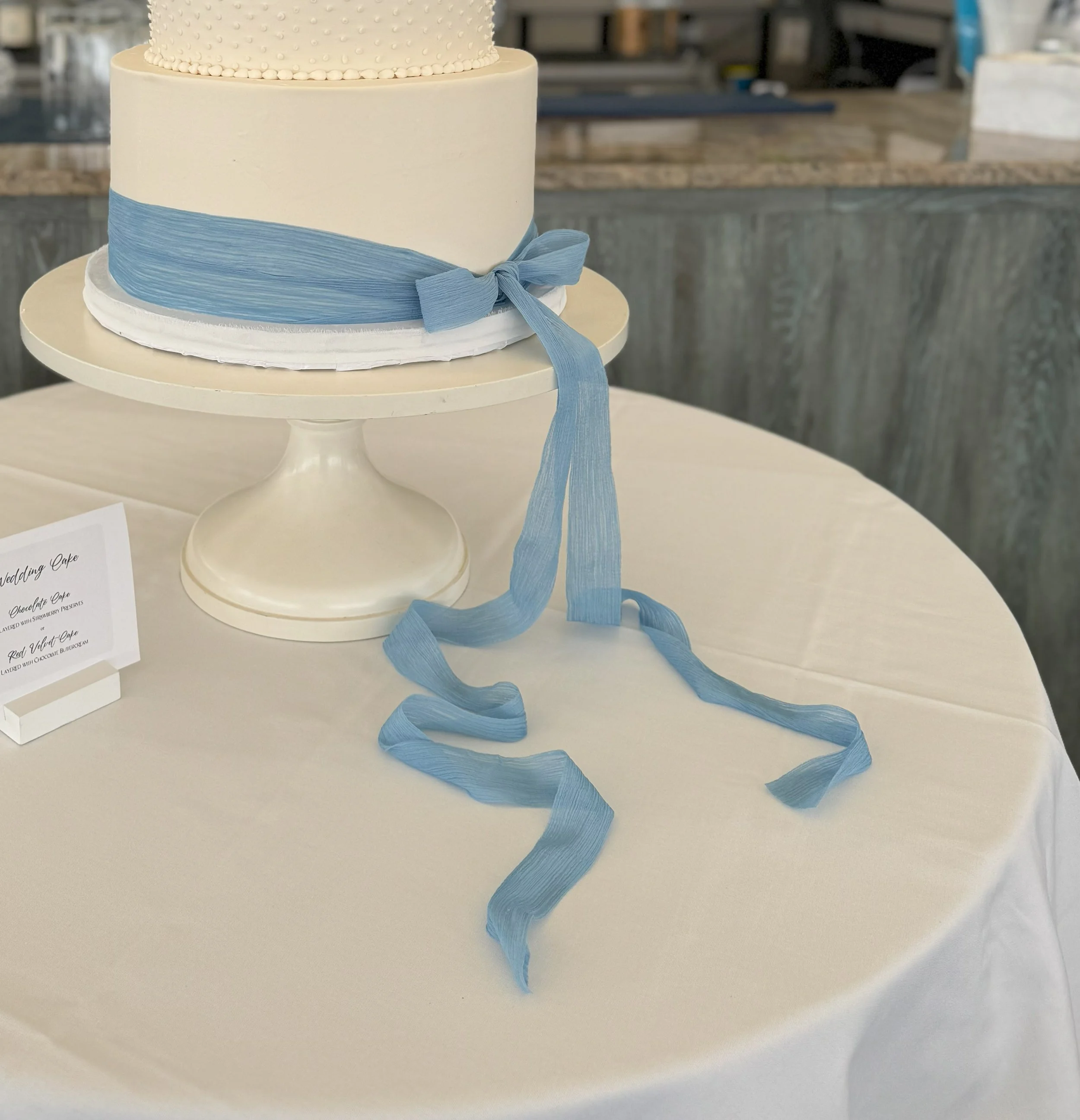 gauze cheesecloth silk bow on wedding cake slate blue hydrangea blue cape cod blue color.jpg