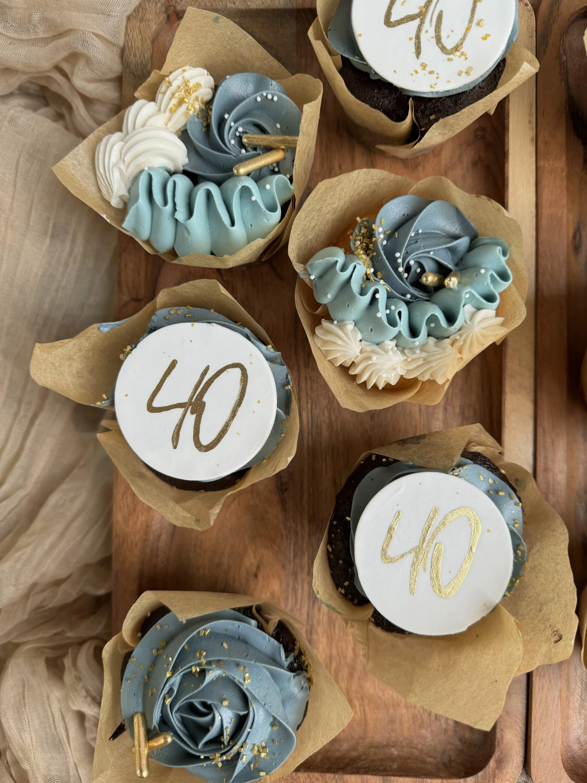 40th birthday dusty blue cupcakes gold blue tulip liner cupcakes.jpeg