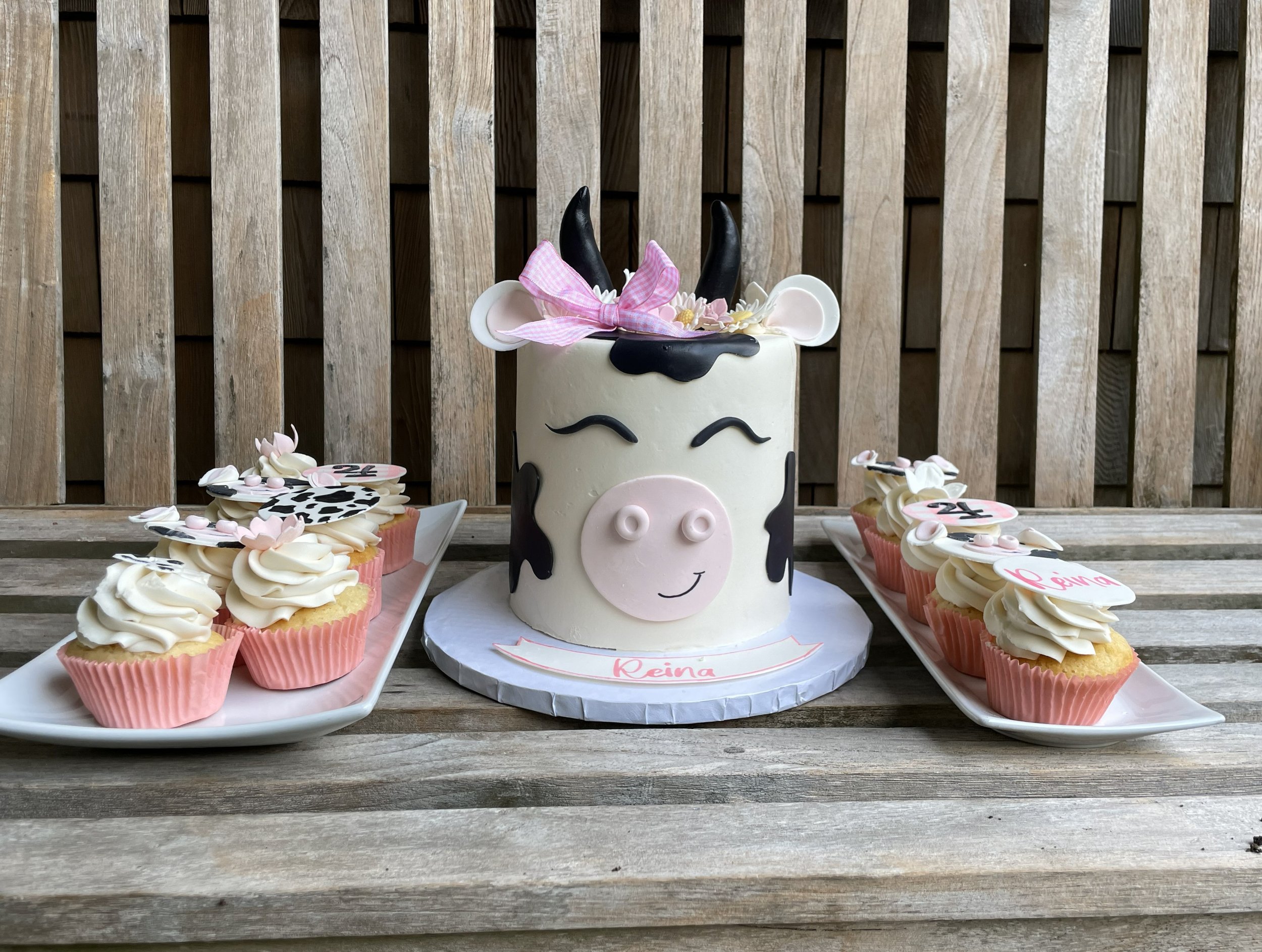cow themed cake with pink bow and flowers .jpg