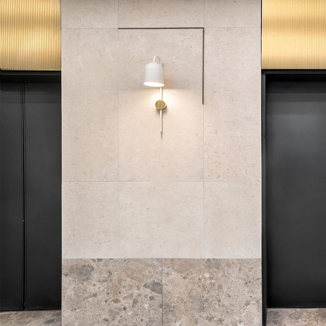 Transition Space / 

Presenting a contemporary lift lobby design that pays homage to the heritage character of the building. The thoughtful use of materials, including bronzed fluted glass and stone tiles, makes a lasting impact. A harmonious blend o