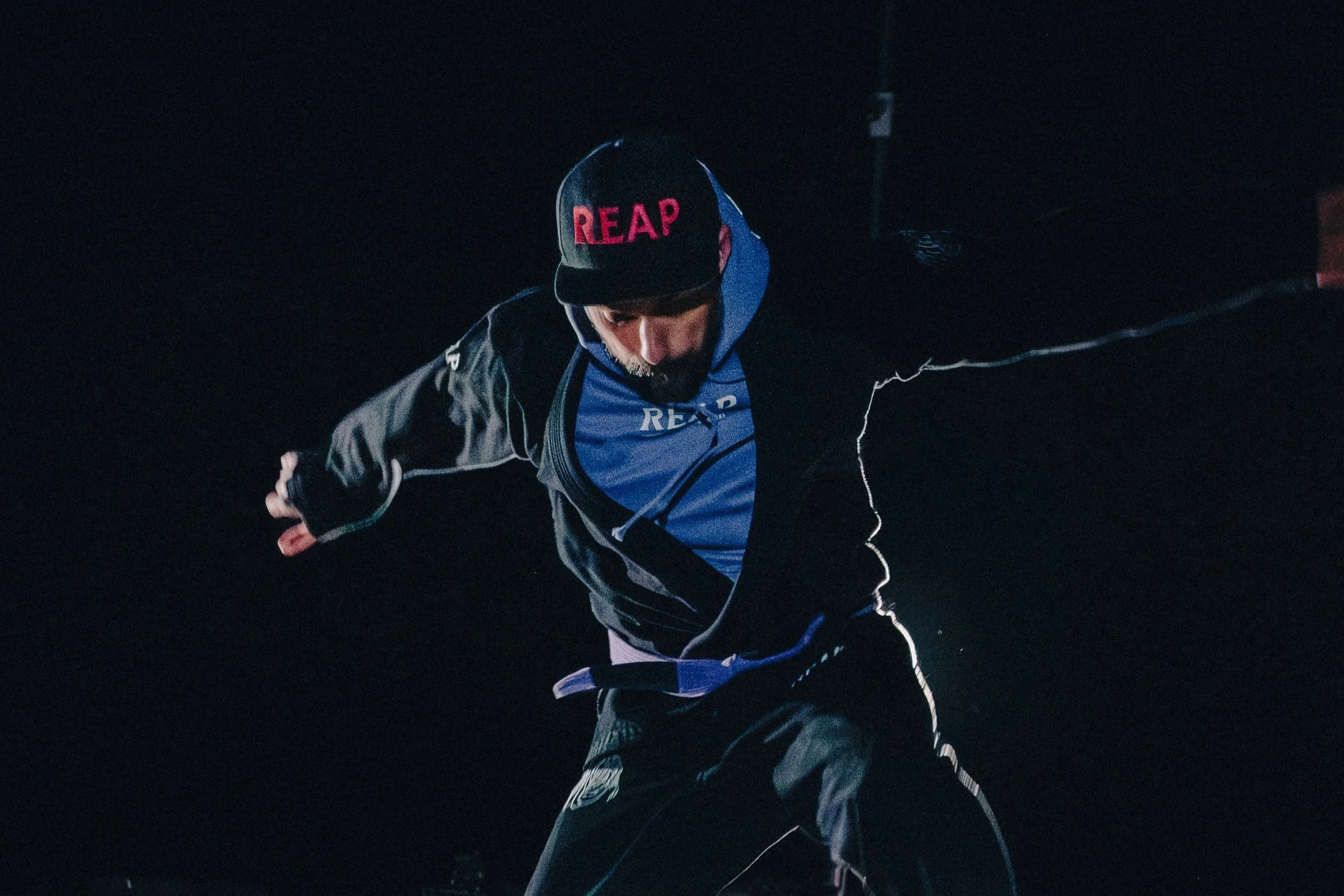 Skateboarder performing a trick on a ramp at night