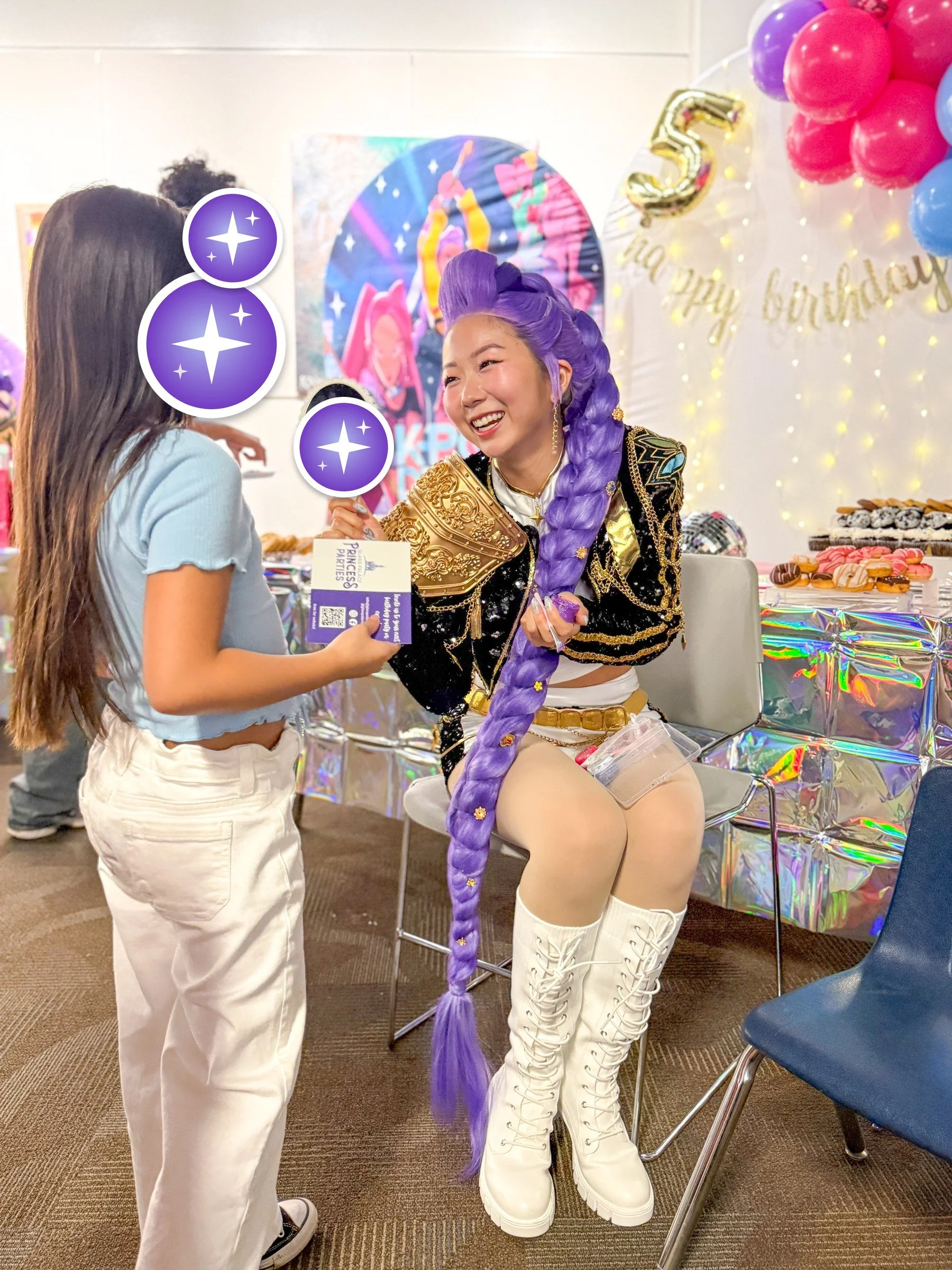 K-Pop star handing an autograph card to a fan at a birthday meet and greet