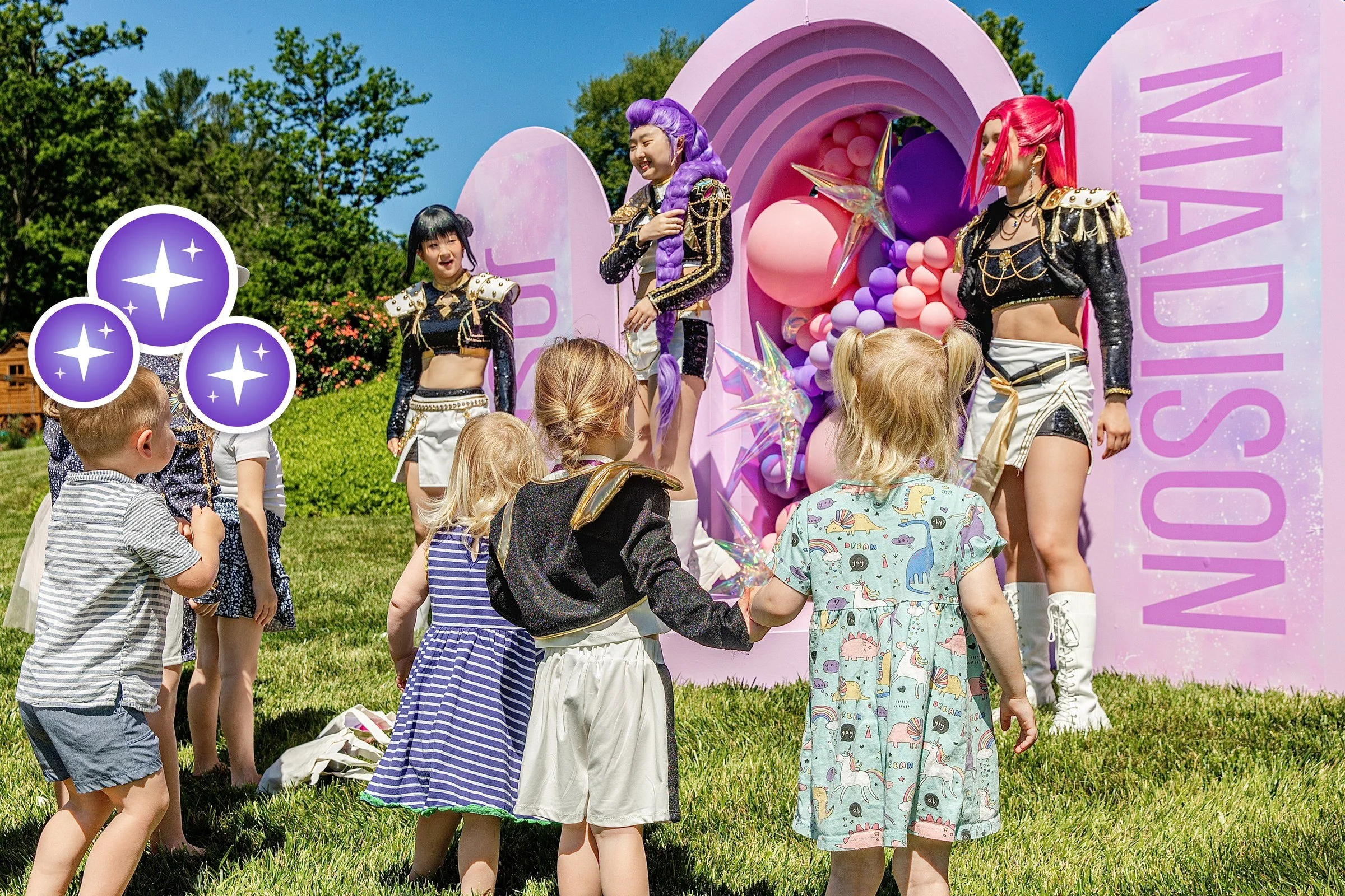Kids dancing with three K-Pop stars at an outdoor birthday party