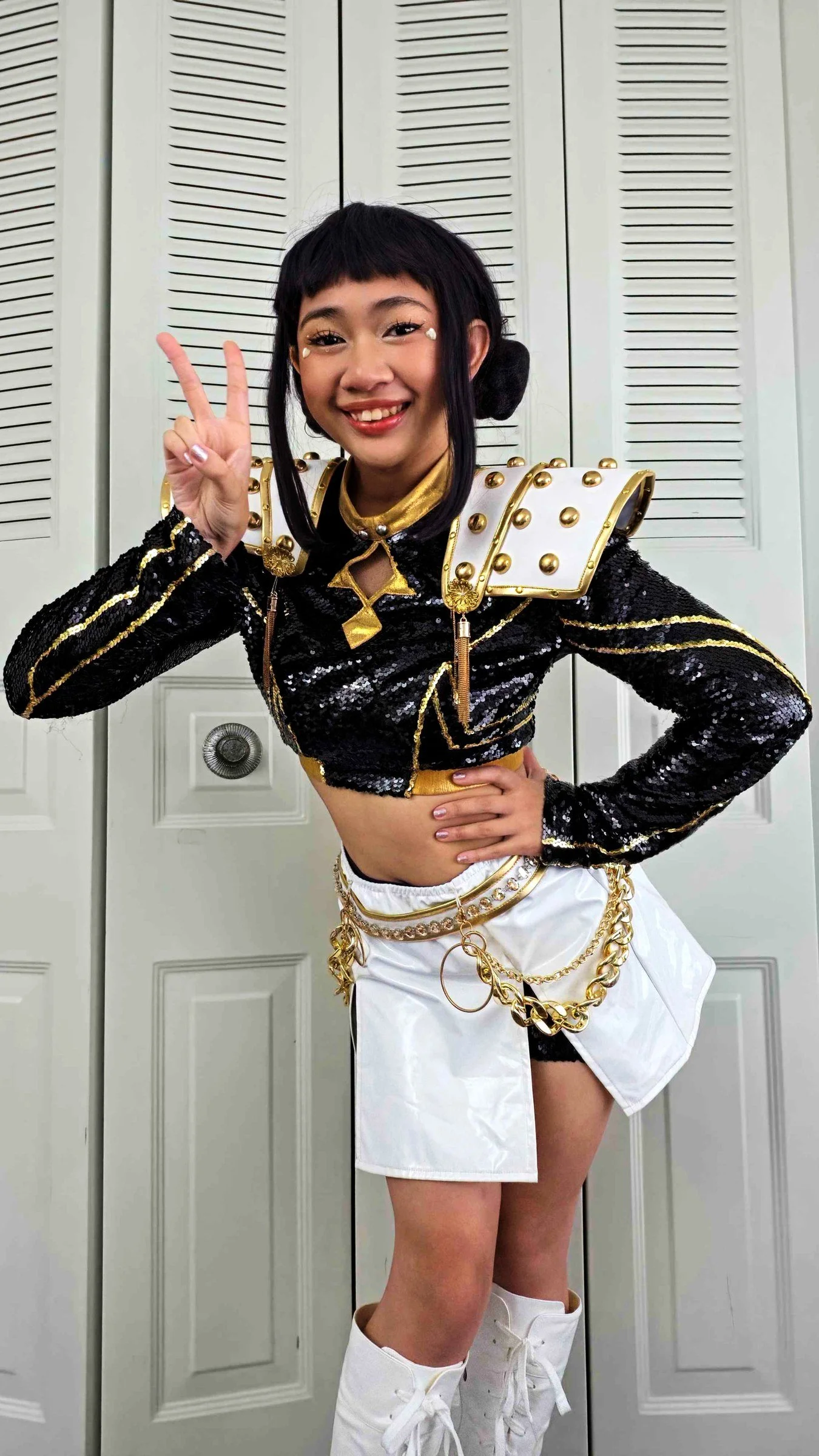 K-Pop performer in a sequined stage jacket, gold details, and idol wig