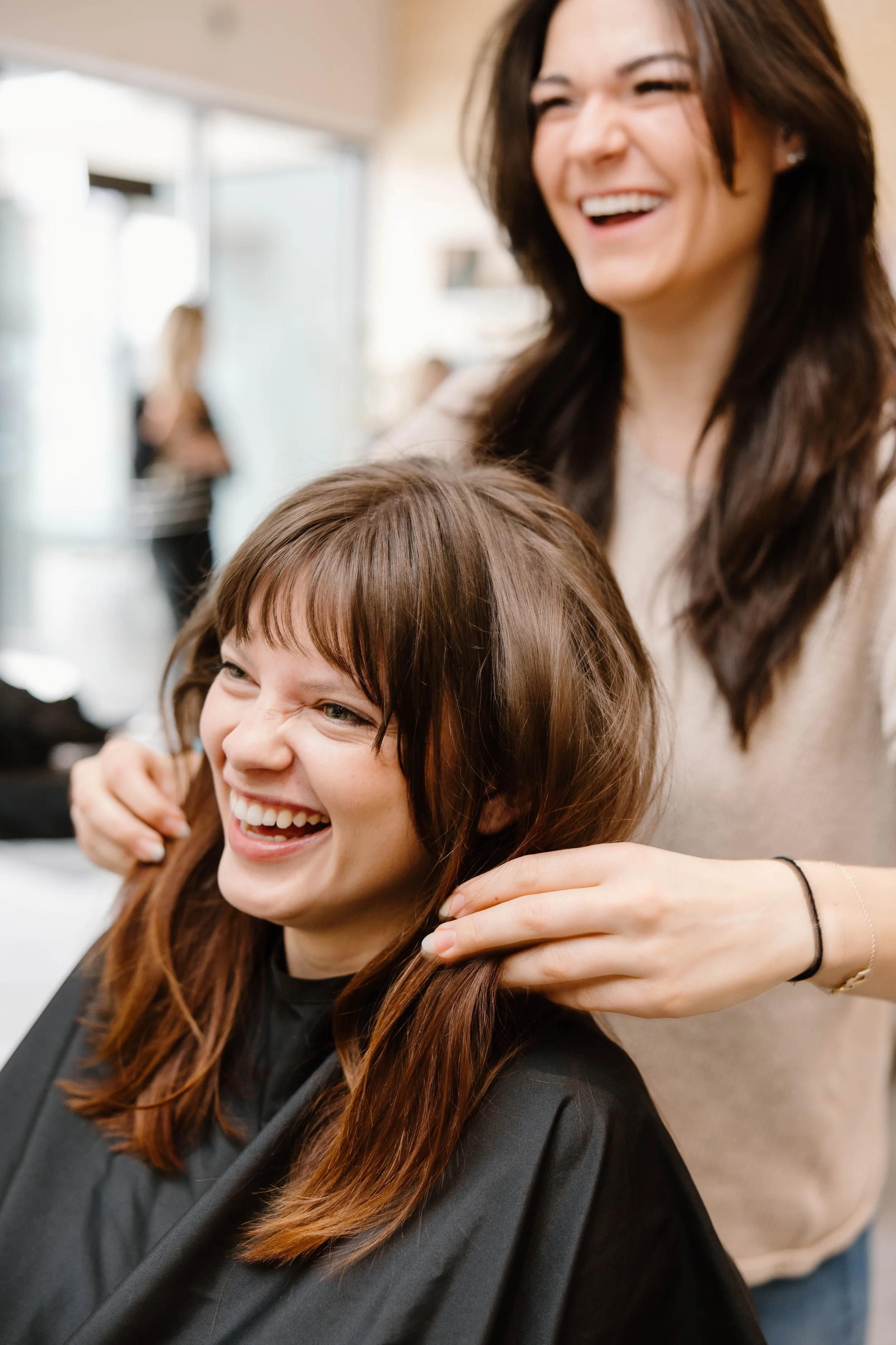 Cedar Rose Salon & Suites colorist consulting with client about hair color options
